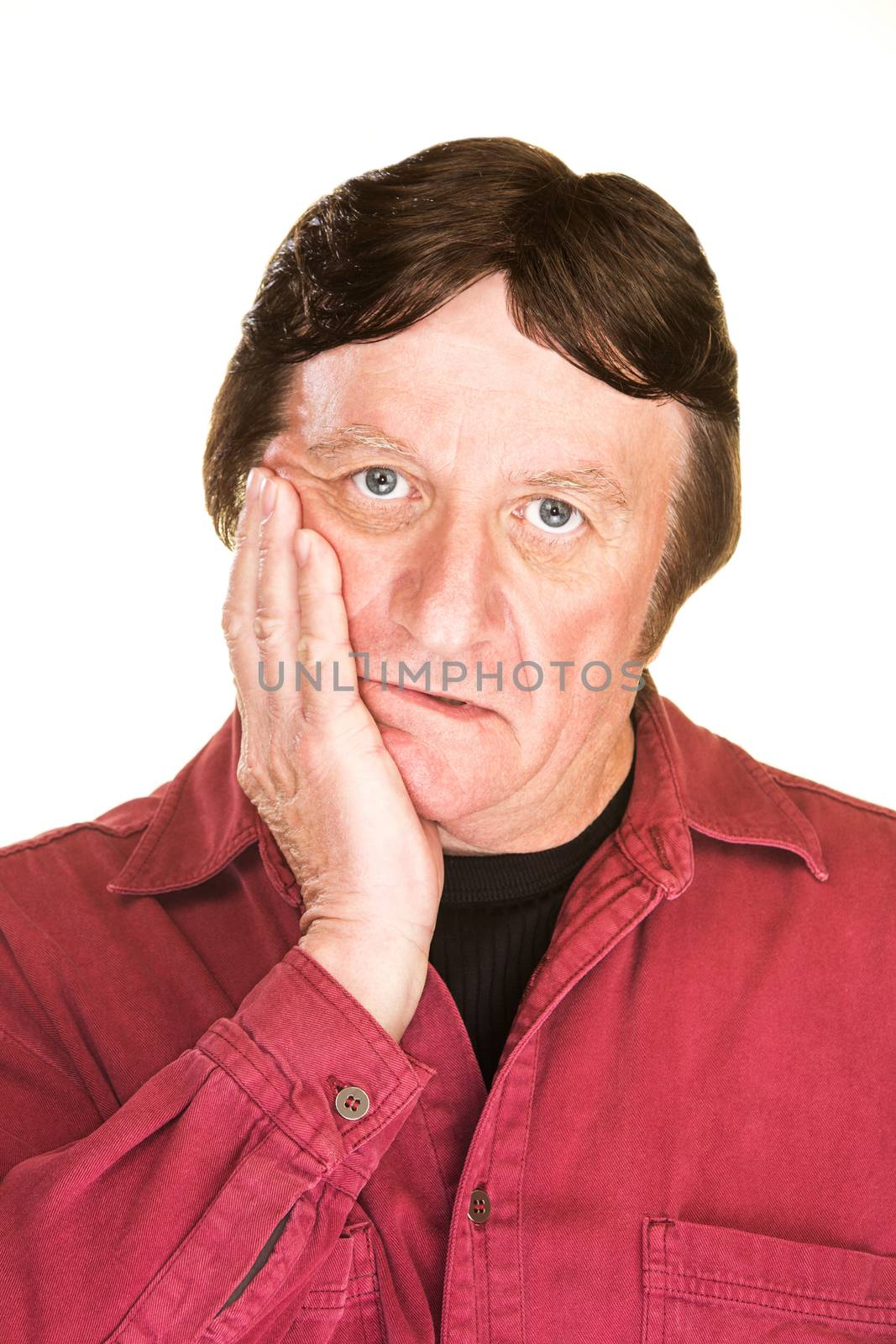 Despairing mature man with hand on cheek over white