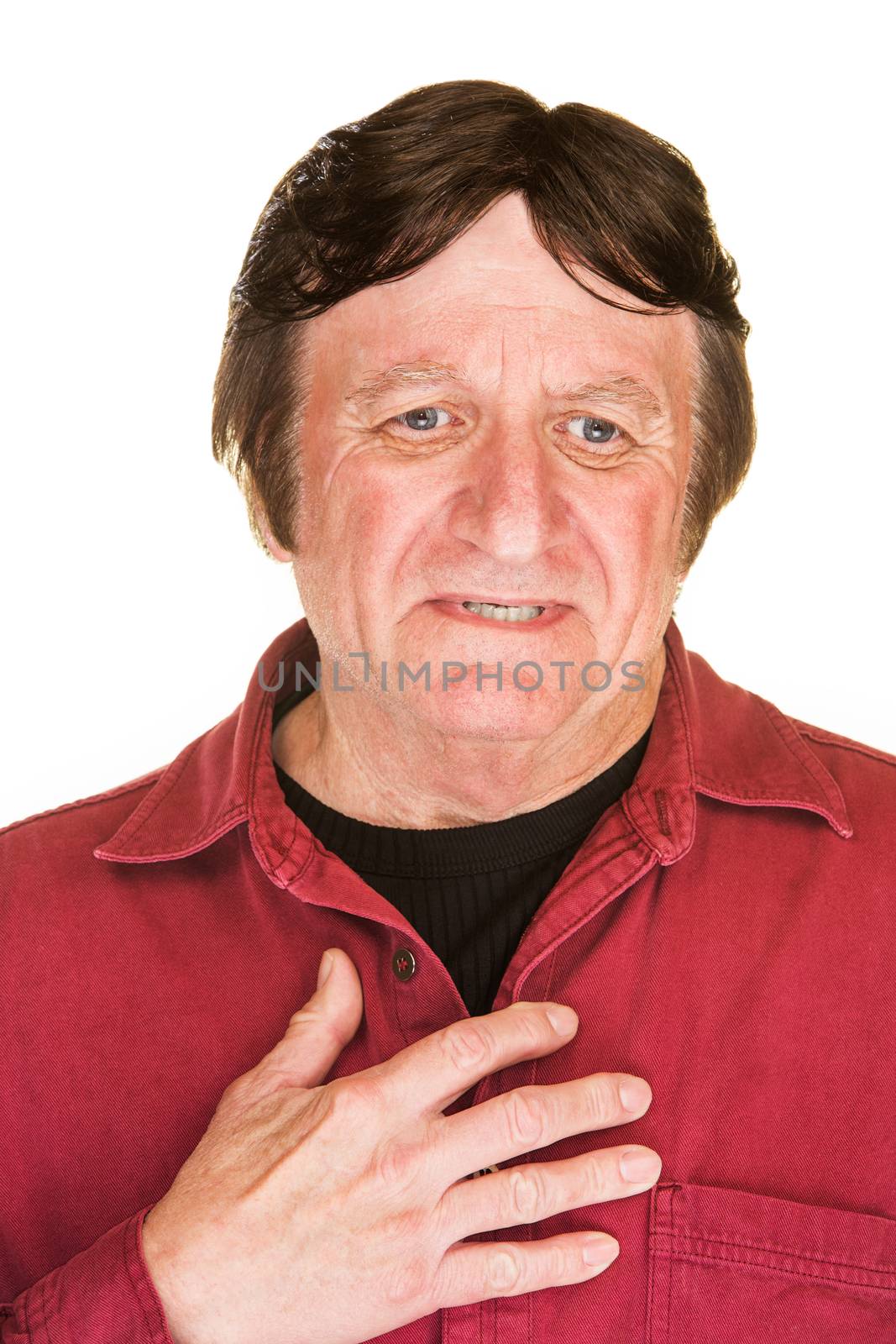 Uncomfortable mature man in red with hand on chest