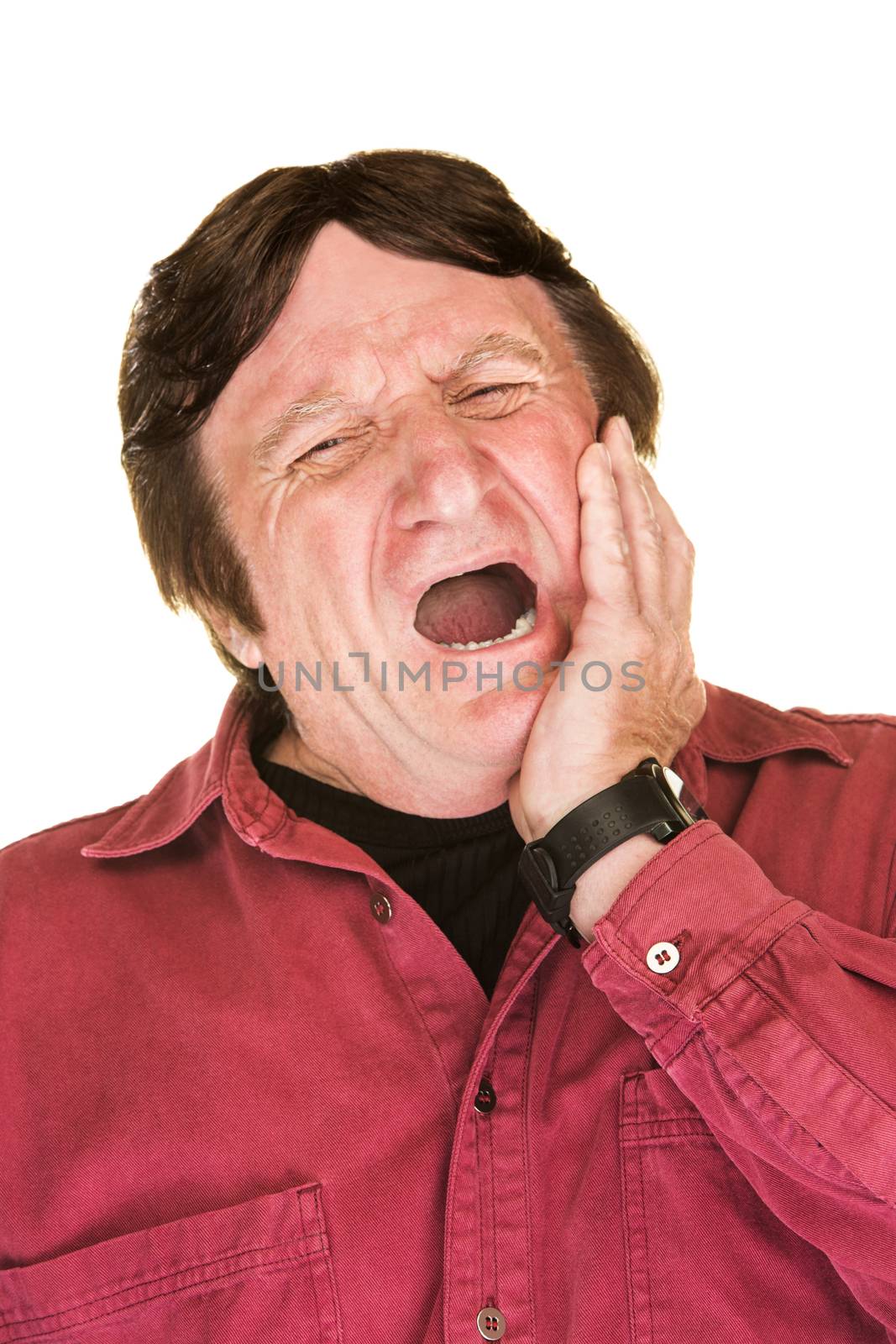 Yawning single man in red over white background