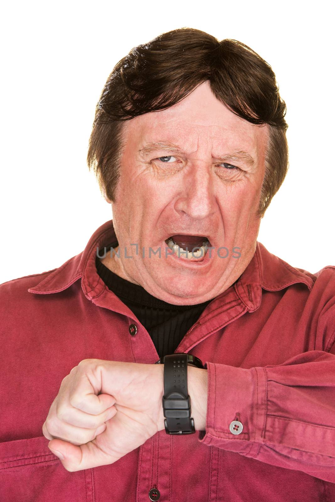 Yawning mature man looking at his watch