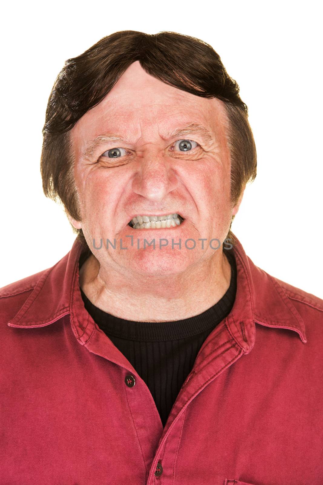 Extremely angry man in red with clenched teeth