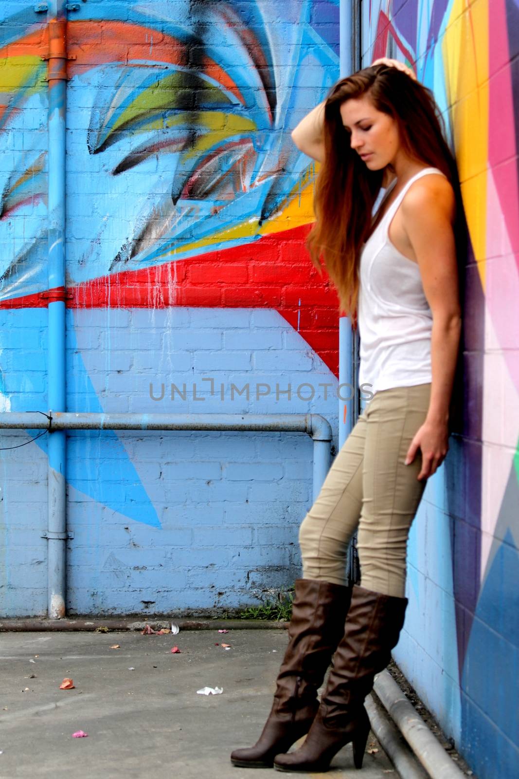 Young woman standing in front of a colorful background.