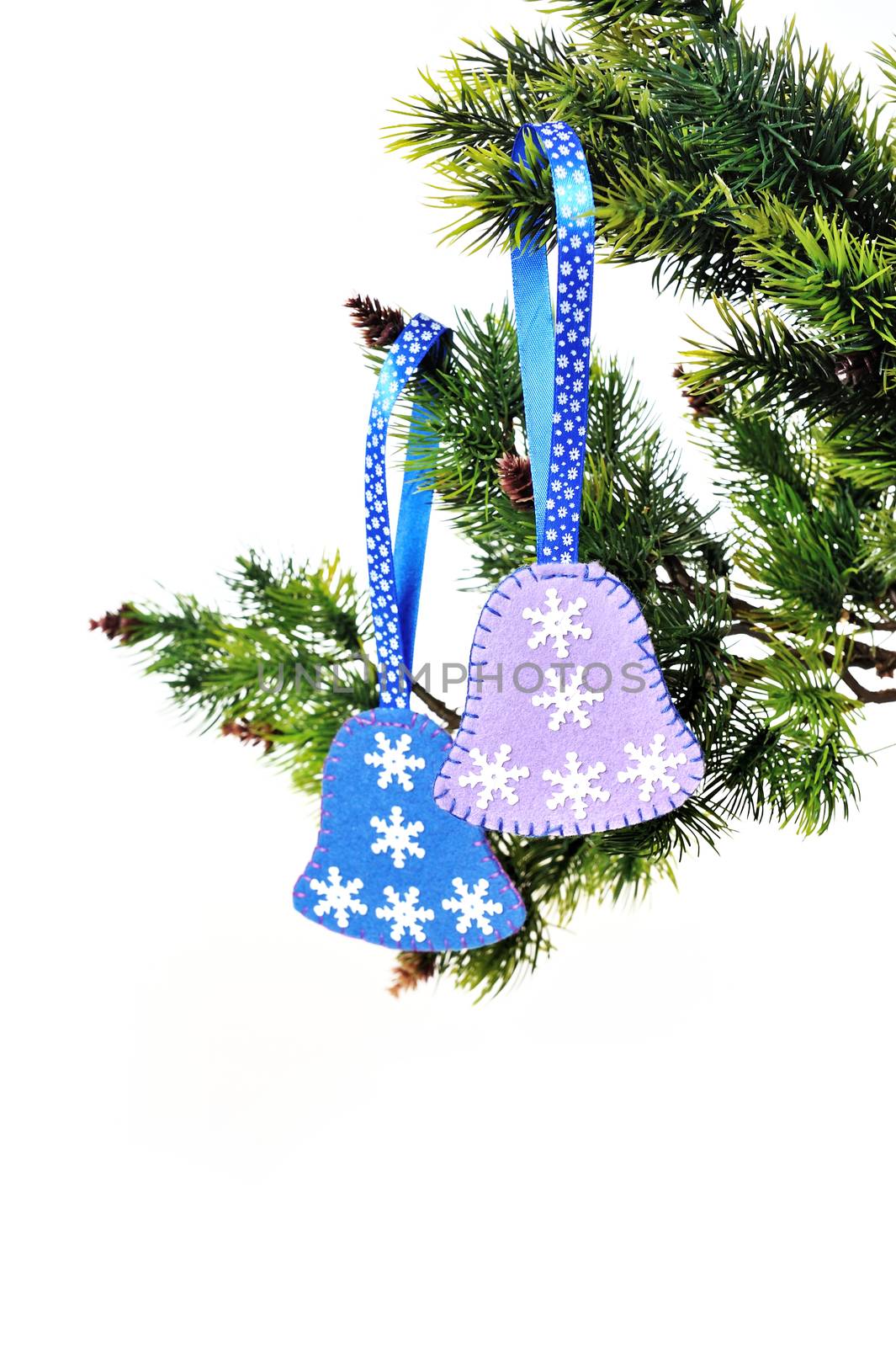 Christmas background, Christmas tree branch with bells toys handmade felt