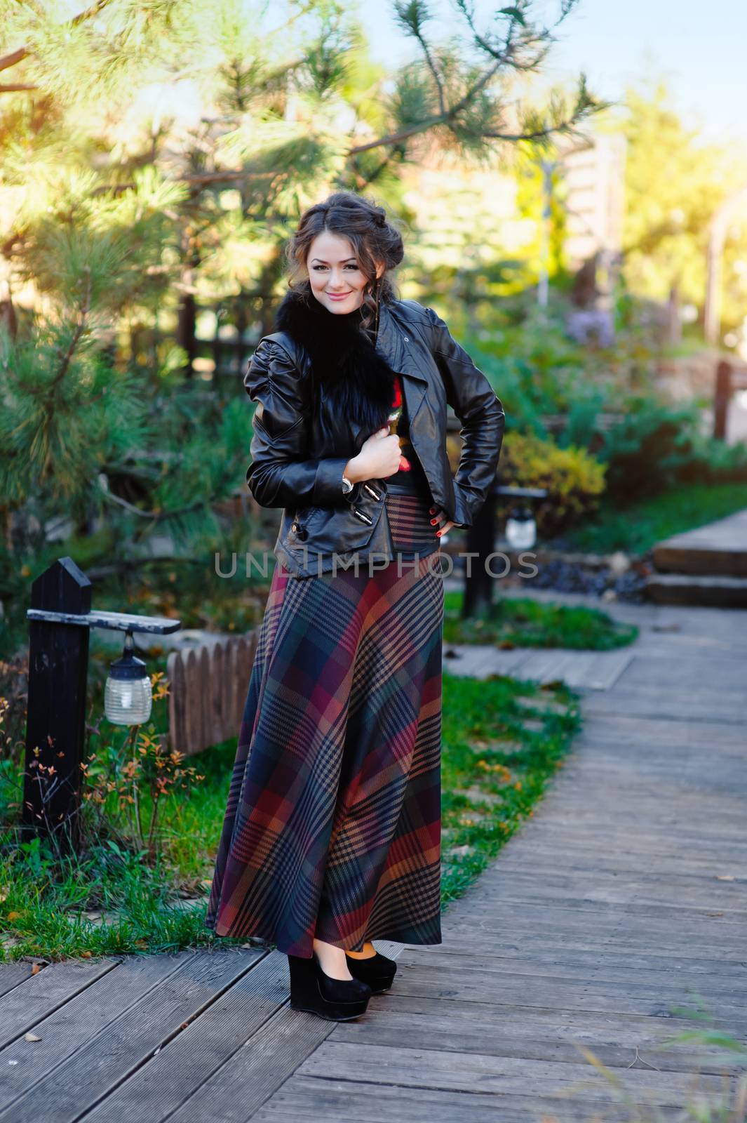 Portrait if young woman walking in spring park.