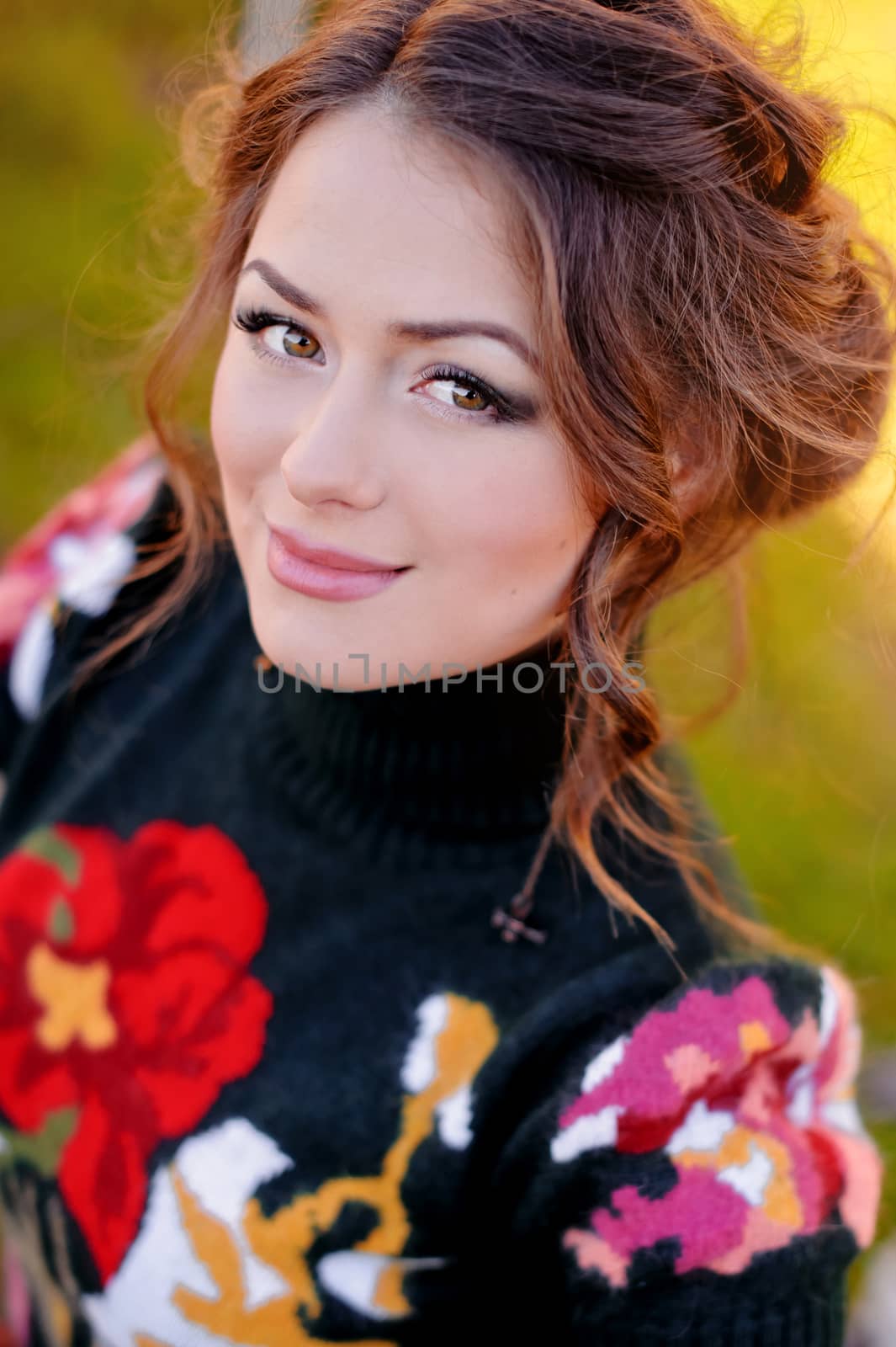 Beautiful charming girl on green summer background. Closeup portrait 