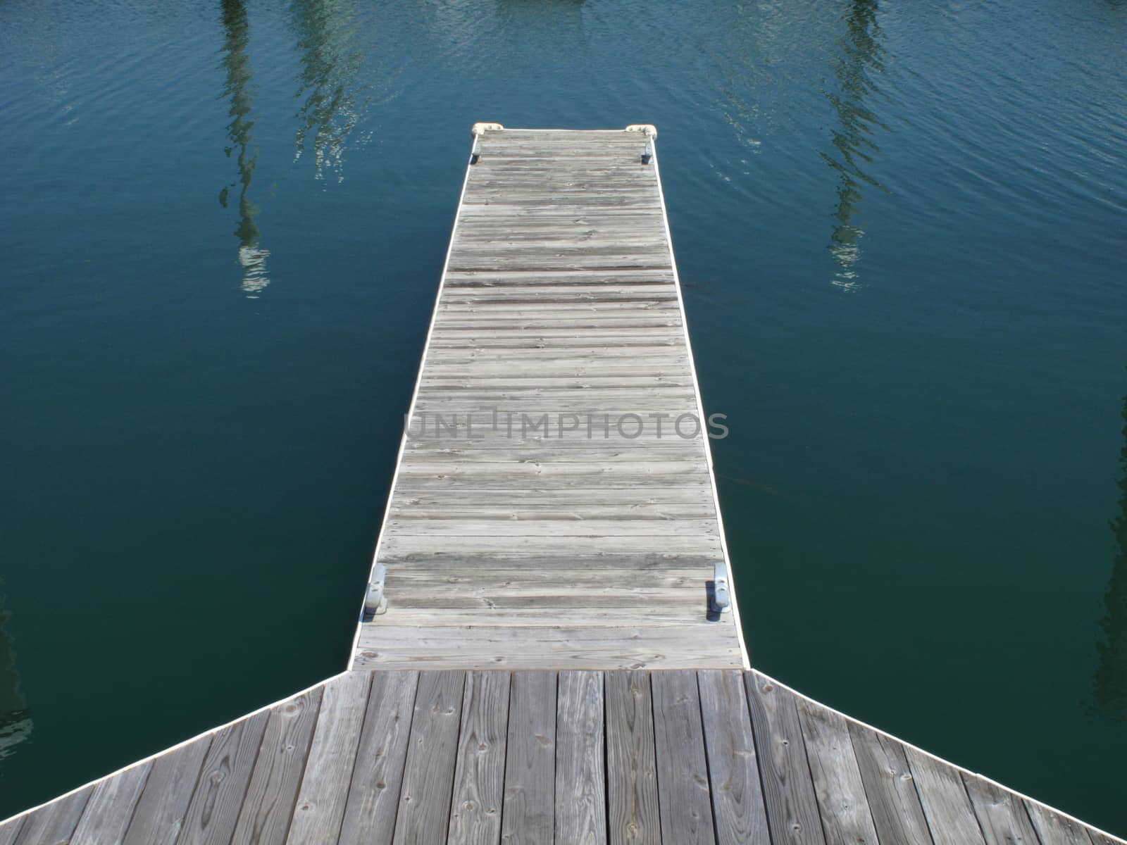 Wooden dock extends into a lake.