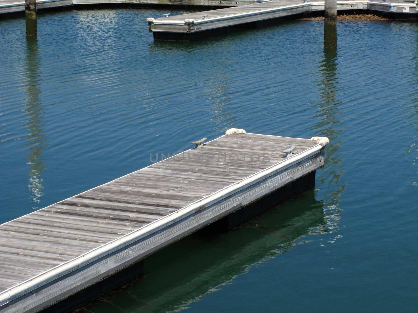 Wooden dock extends into a lake.