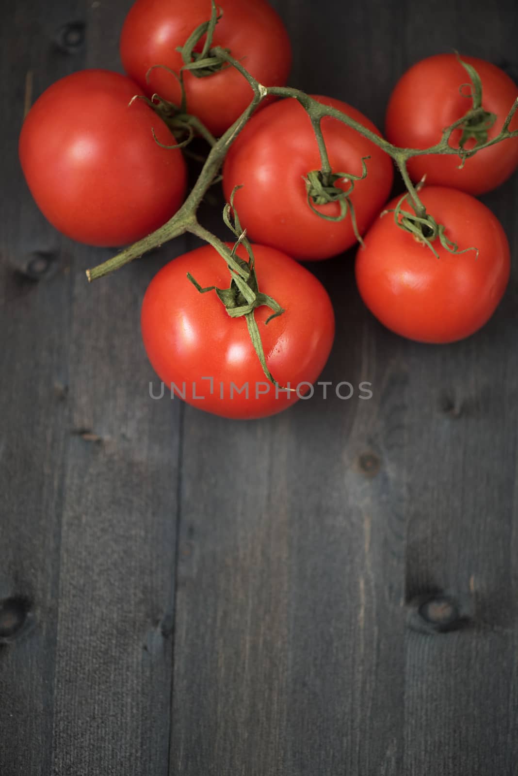 Fresh tomatoes on vintage wooden table
