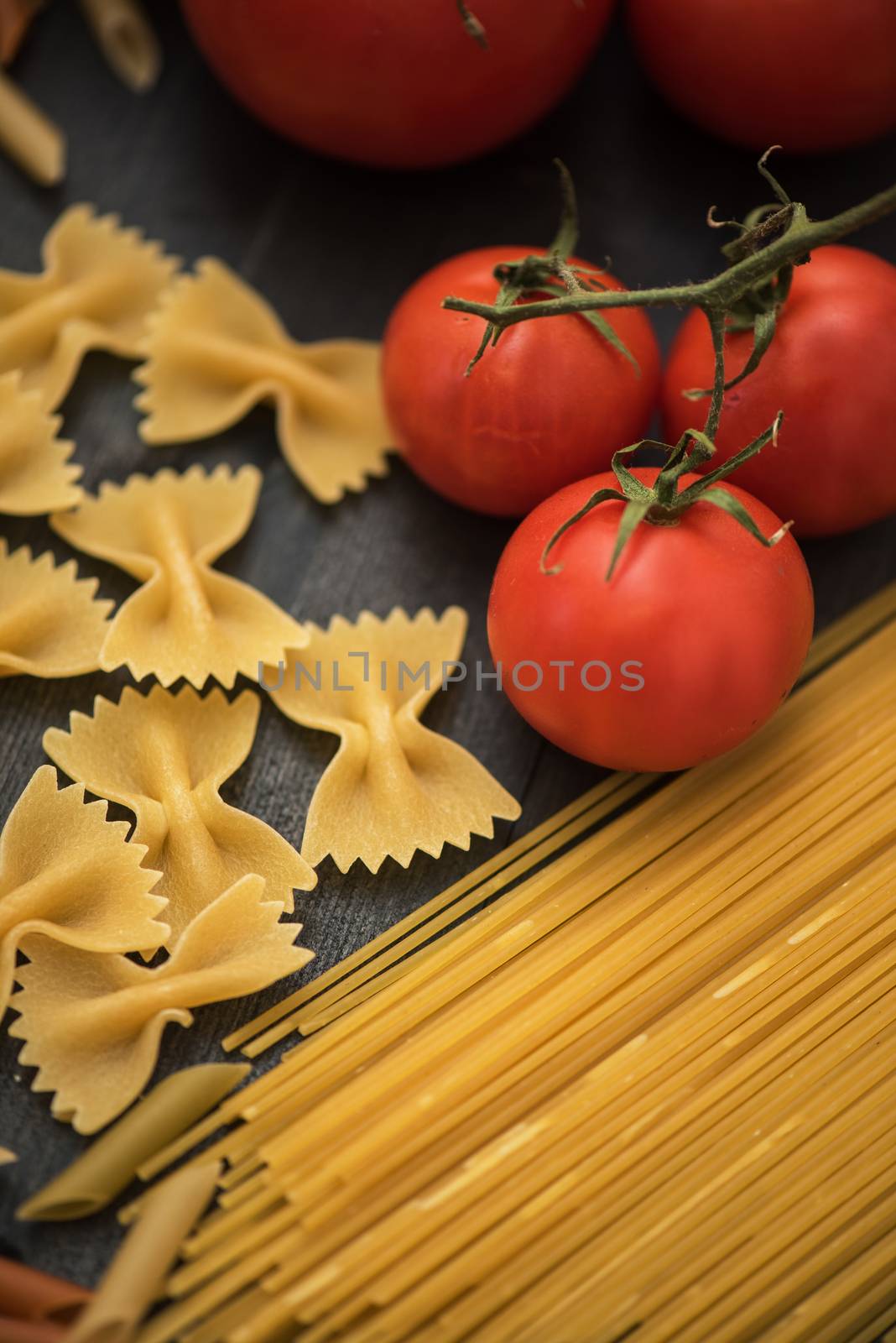 food background on rustic wood with pasta and tomatoes