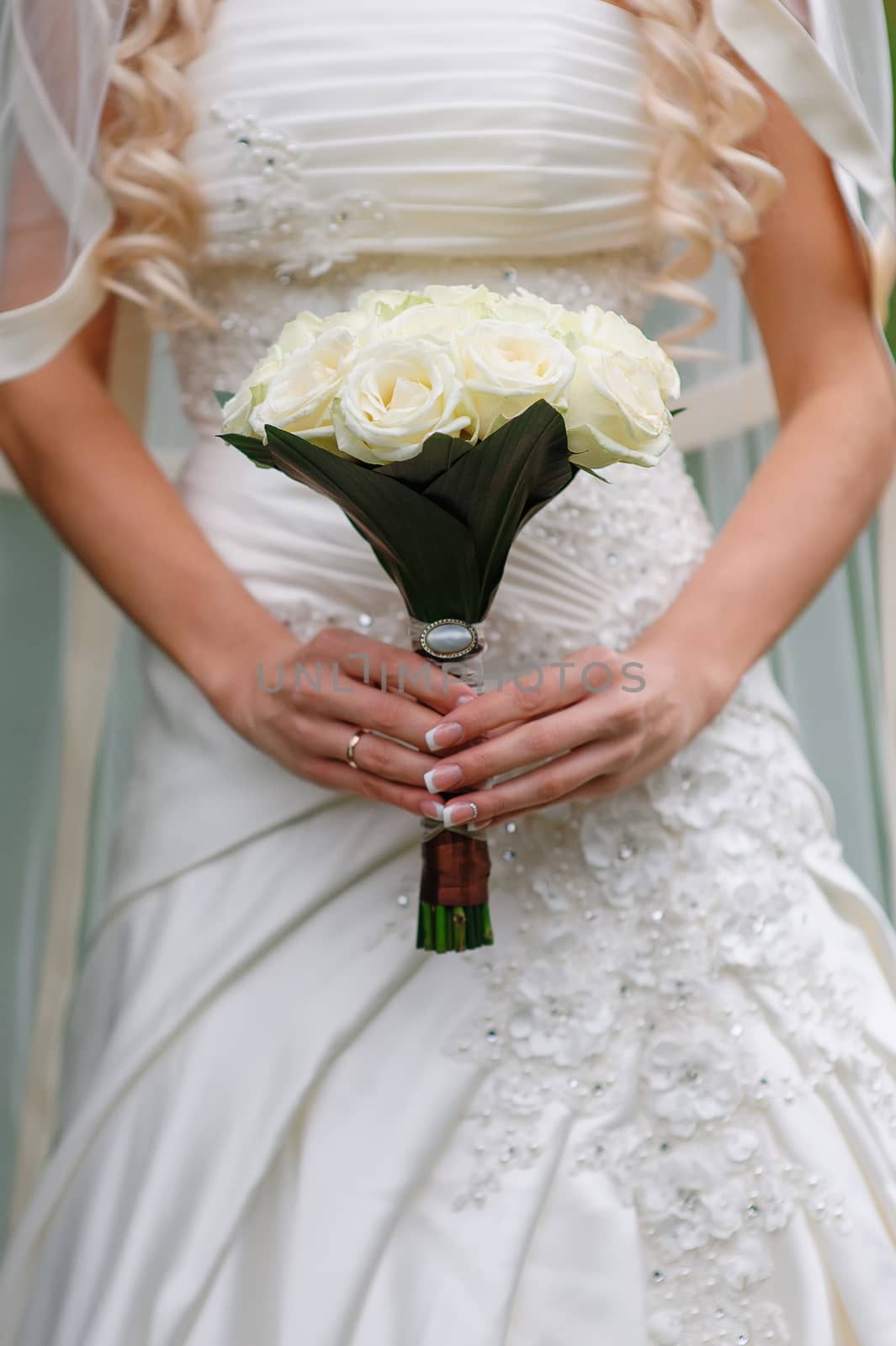 Beautiful wedding bouquet in hands of the bride