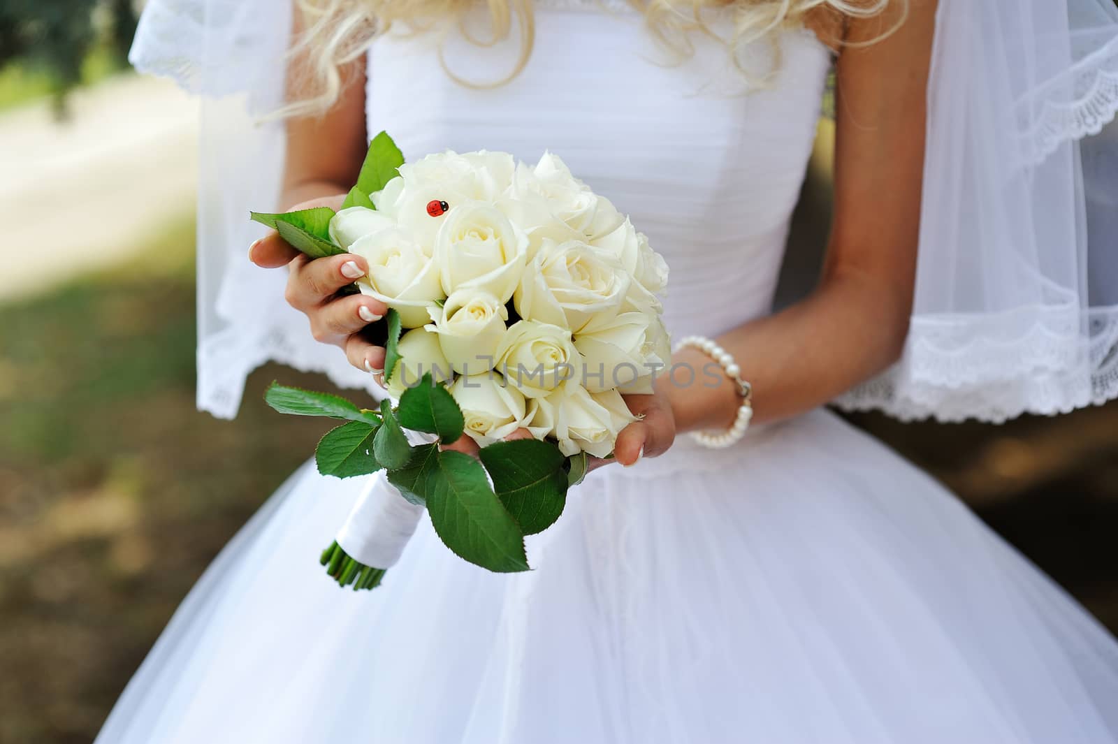 Beautiful wedding bouquet in hands of the bride