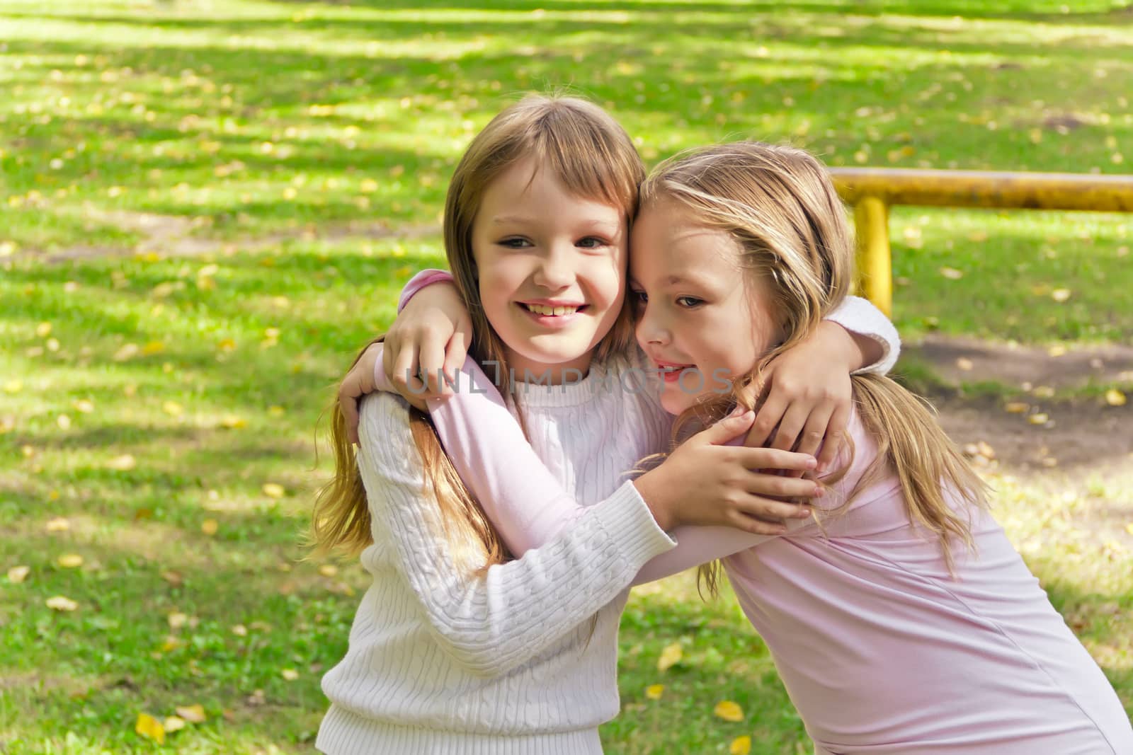 Photo of two embracing girls in summer