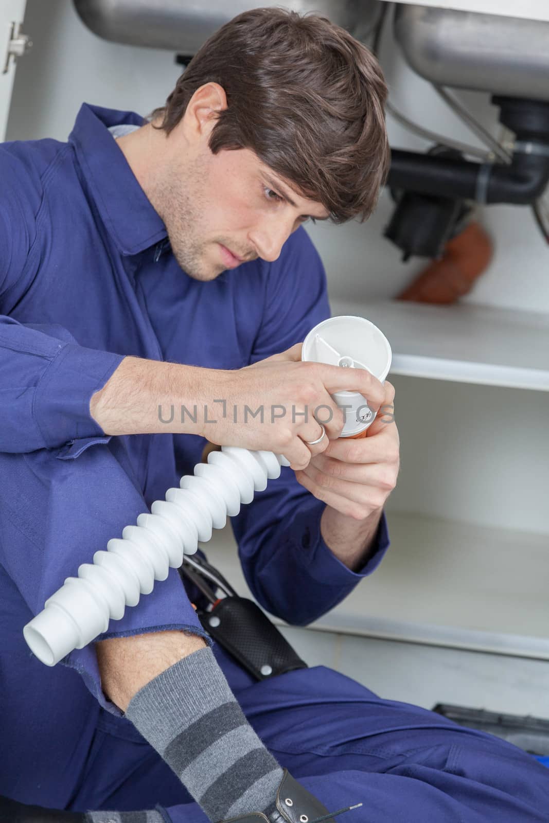 Plumber installing a pipe
