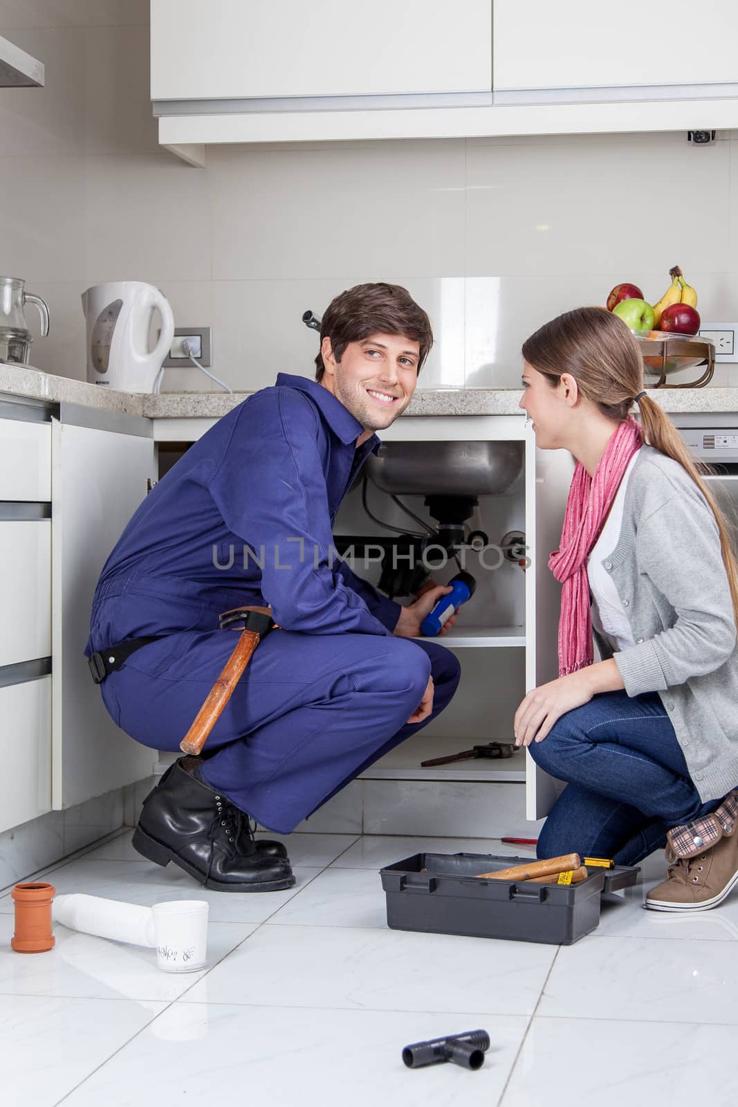 Woman supervising plumber