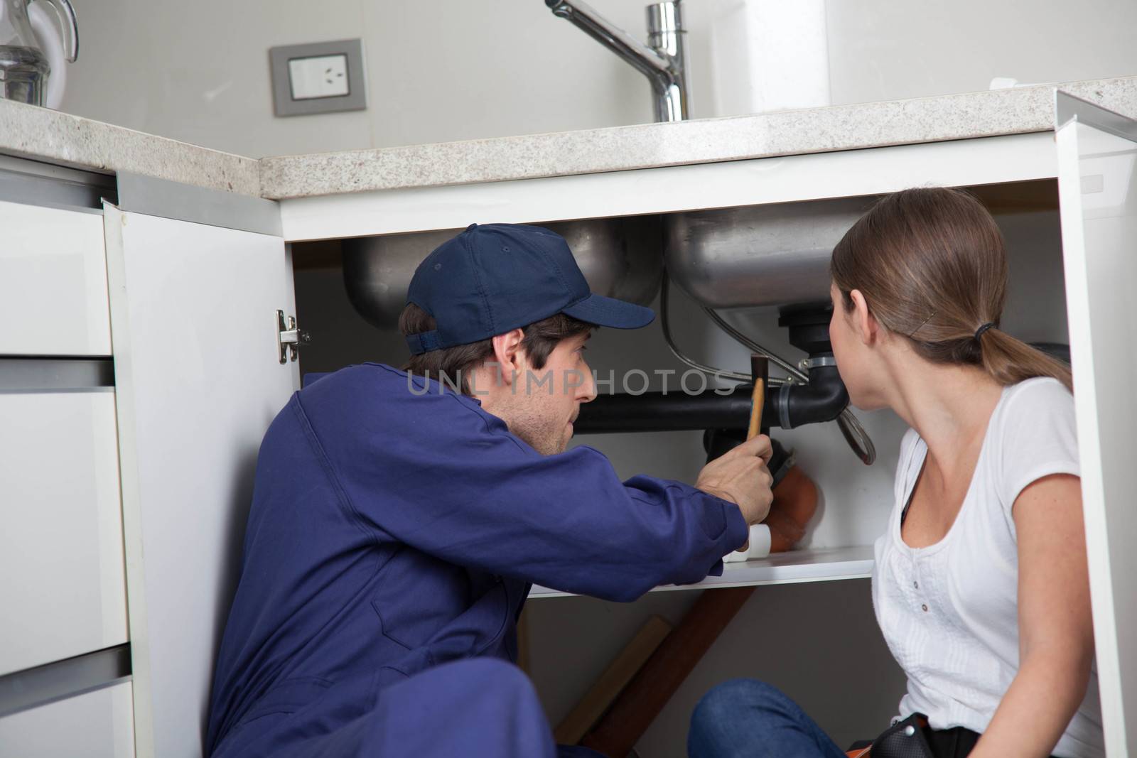 Couple plumbers fixing the pipes