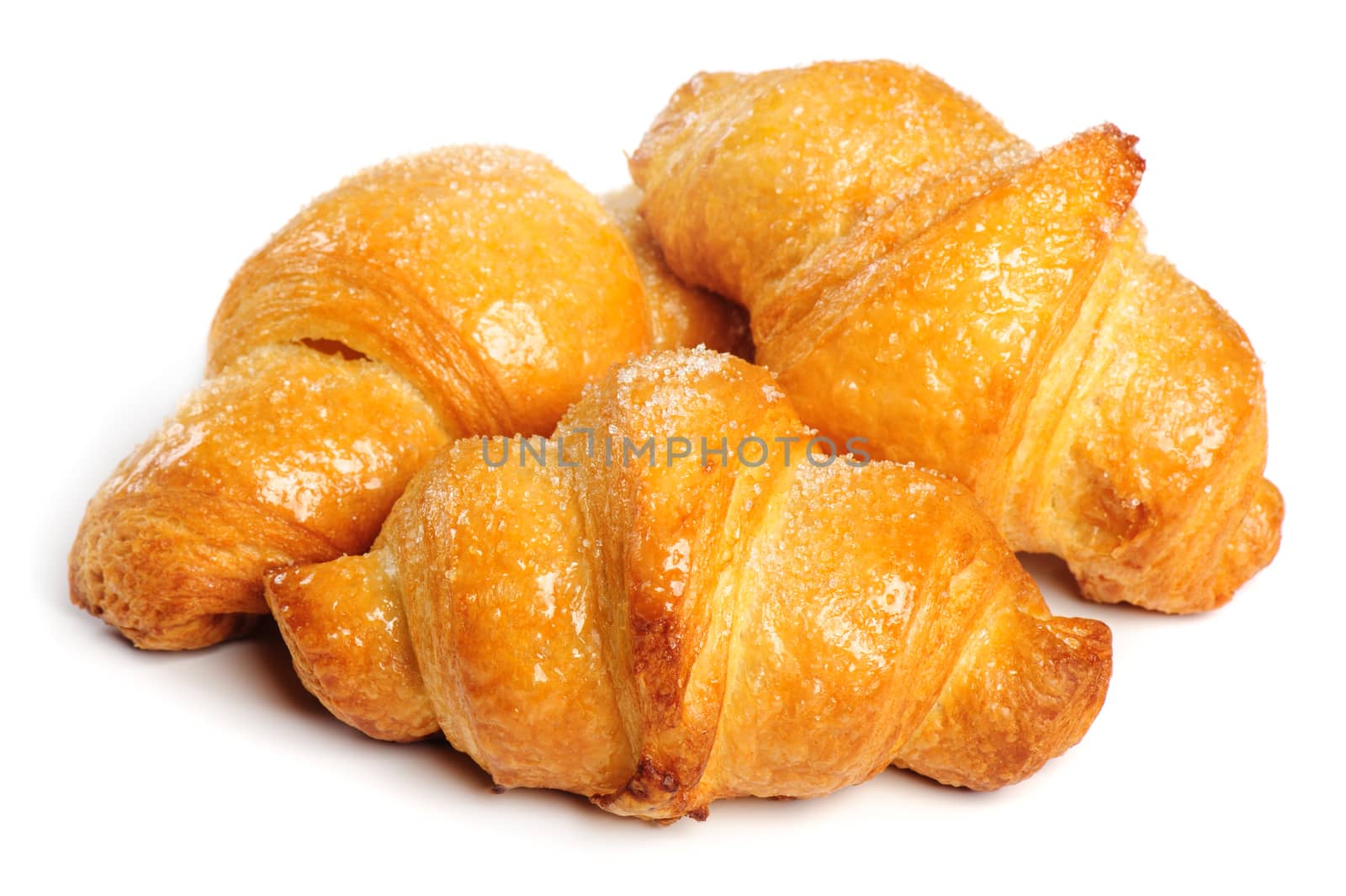 Three fresh just baked croissants on white background, isolated