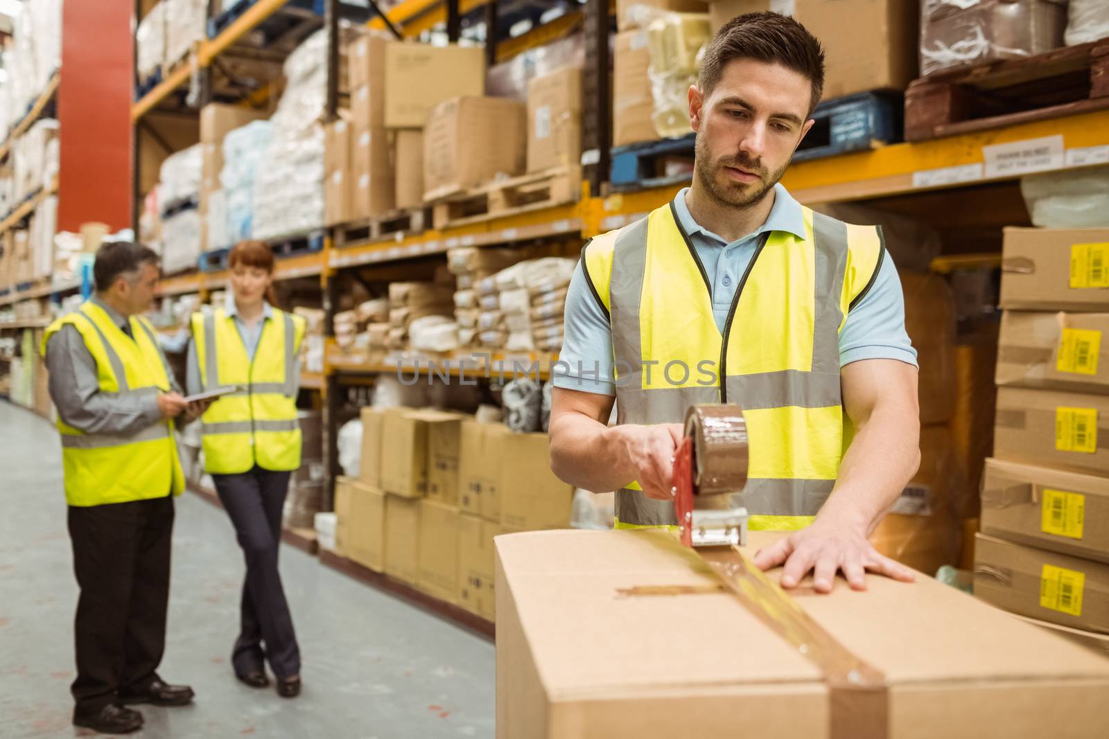 Warehouse workers preparing a shipment in a large warehouse