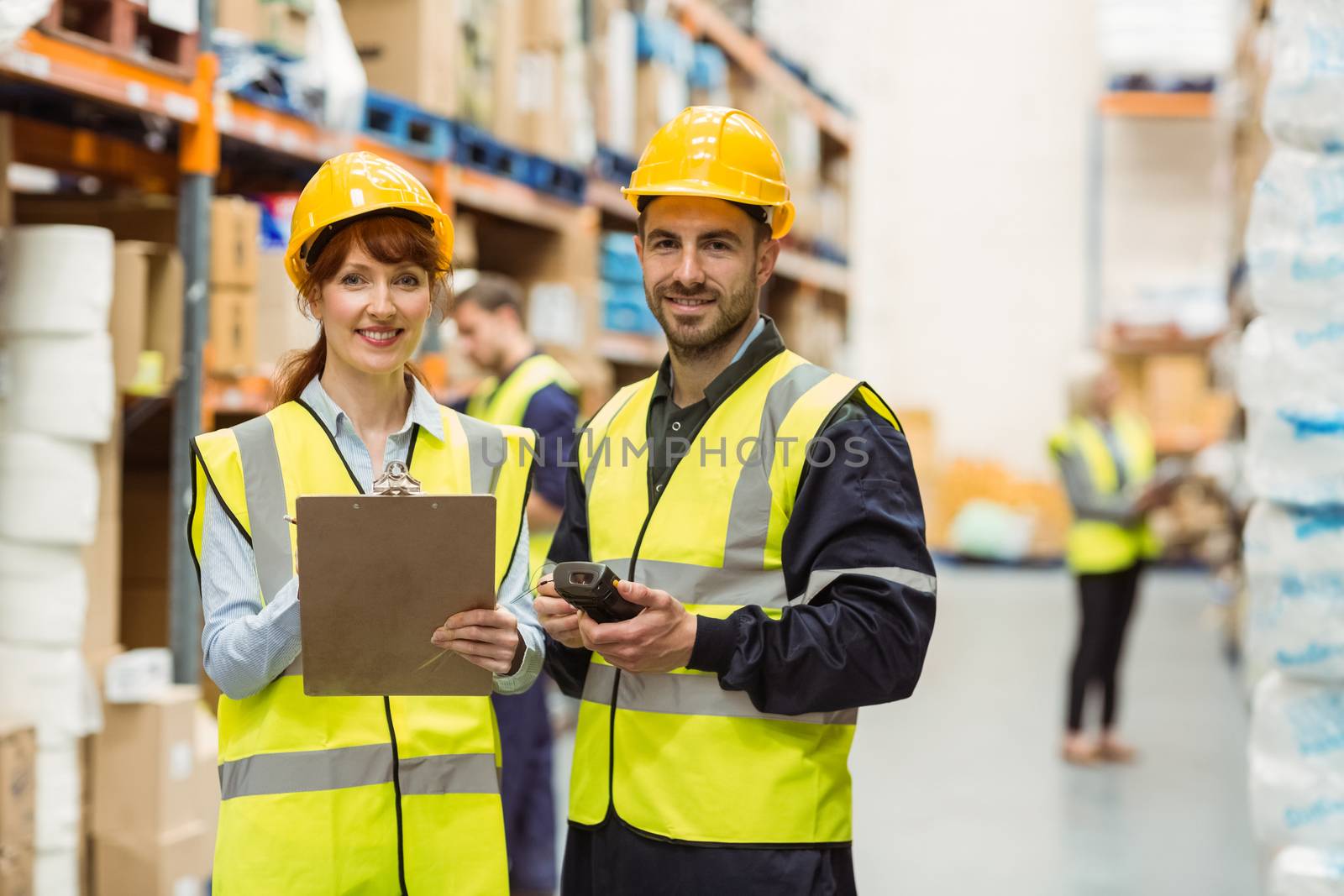 Warehouse manager talking with worker in a large warehouse