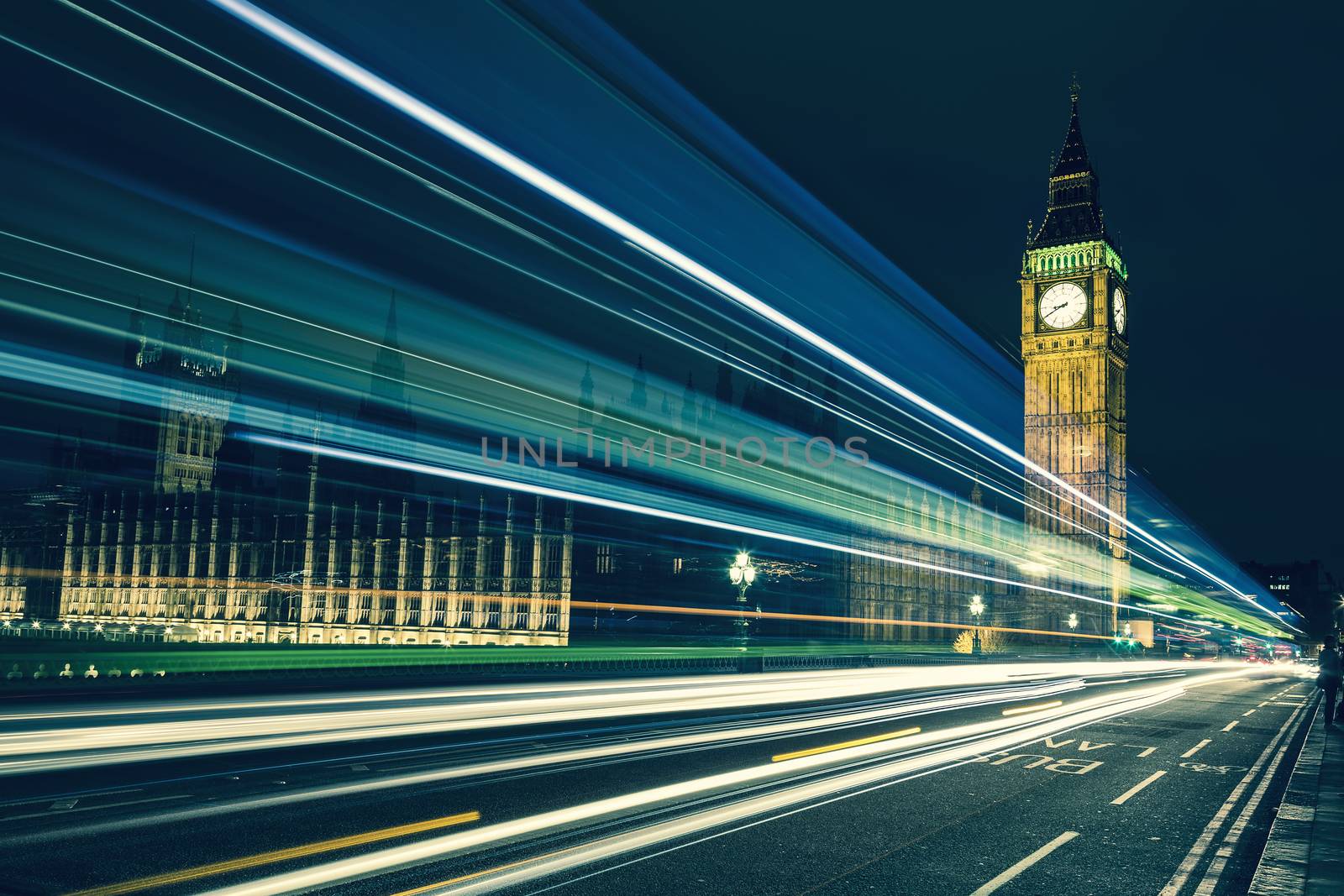 Big Ben, one of the most prominent symbols of both London and England, as shown at night along with the lights of the cars passing by