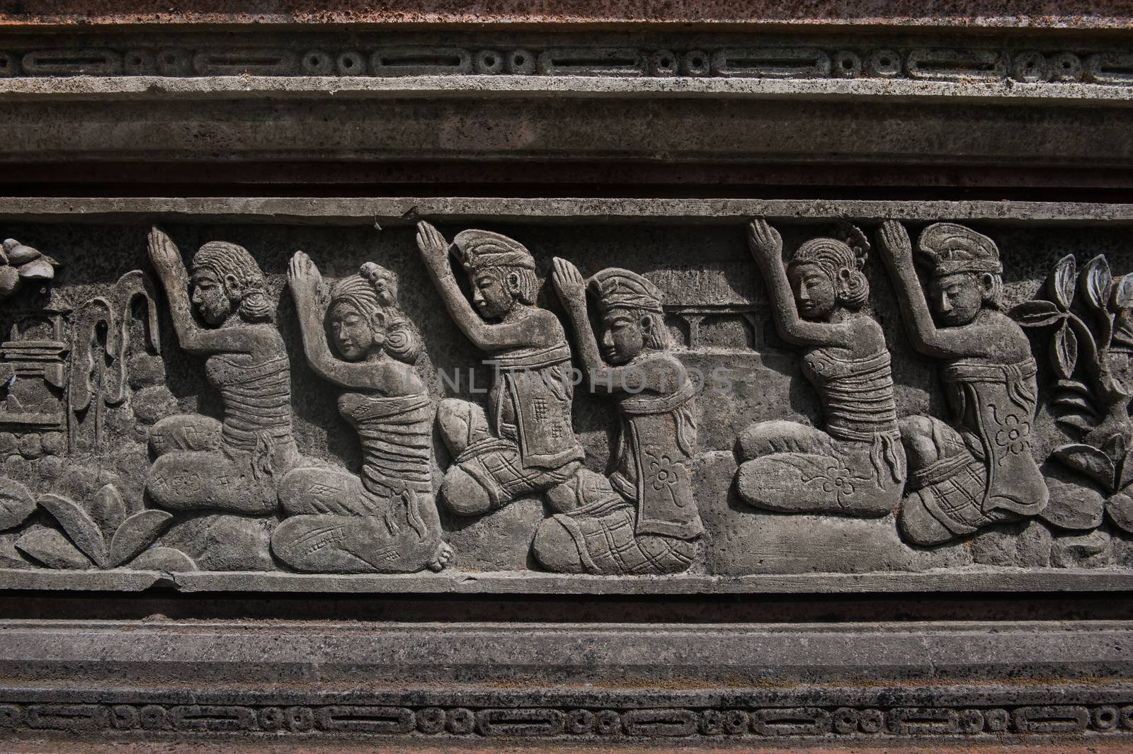 Traditional Hindu sculpturing, showing the ceremony of worshiping of Balinese prayers.