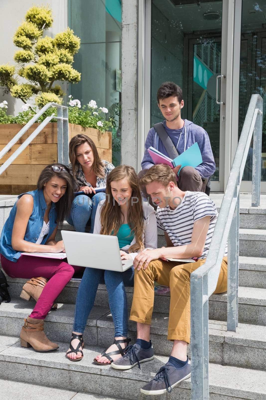 Students sitting on steps studying at the university