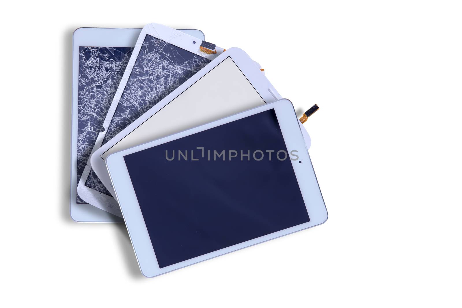Fanned arrangement of four tablets with blank screens showing two with smashed broken glass and two with repaired screens in the corner on white with copyspace