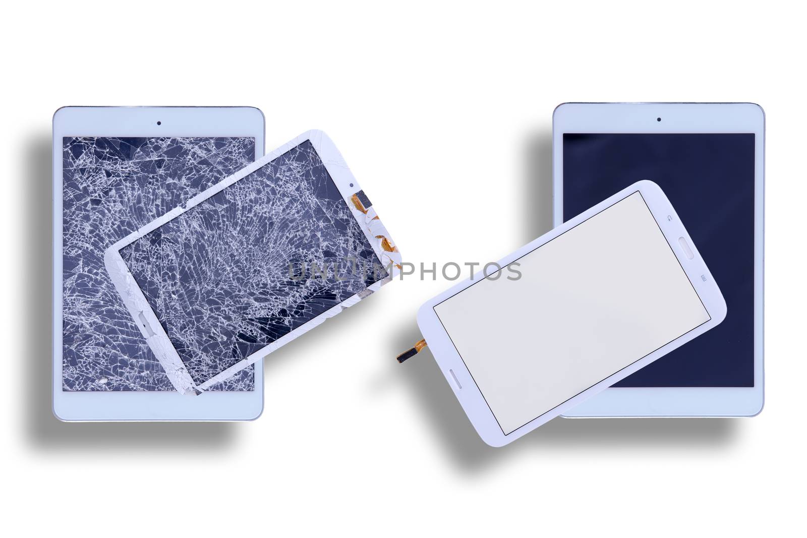Overhead view of two tablets with shattered glass screens alongside two with repaired tablet screens in a comparative image on a white background