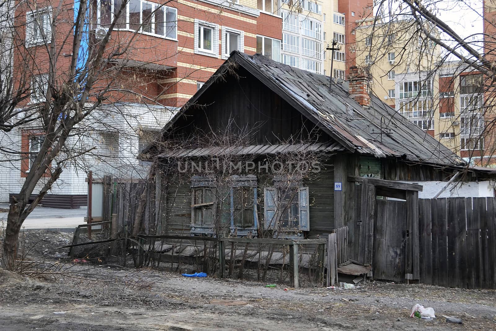 Old wooden houses against modern high-rise buildings. Tyumen, Ru by veronka72