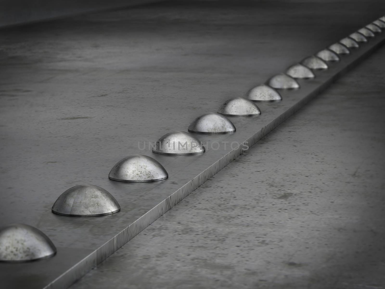 Row of rivets on the metal grunge background