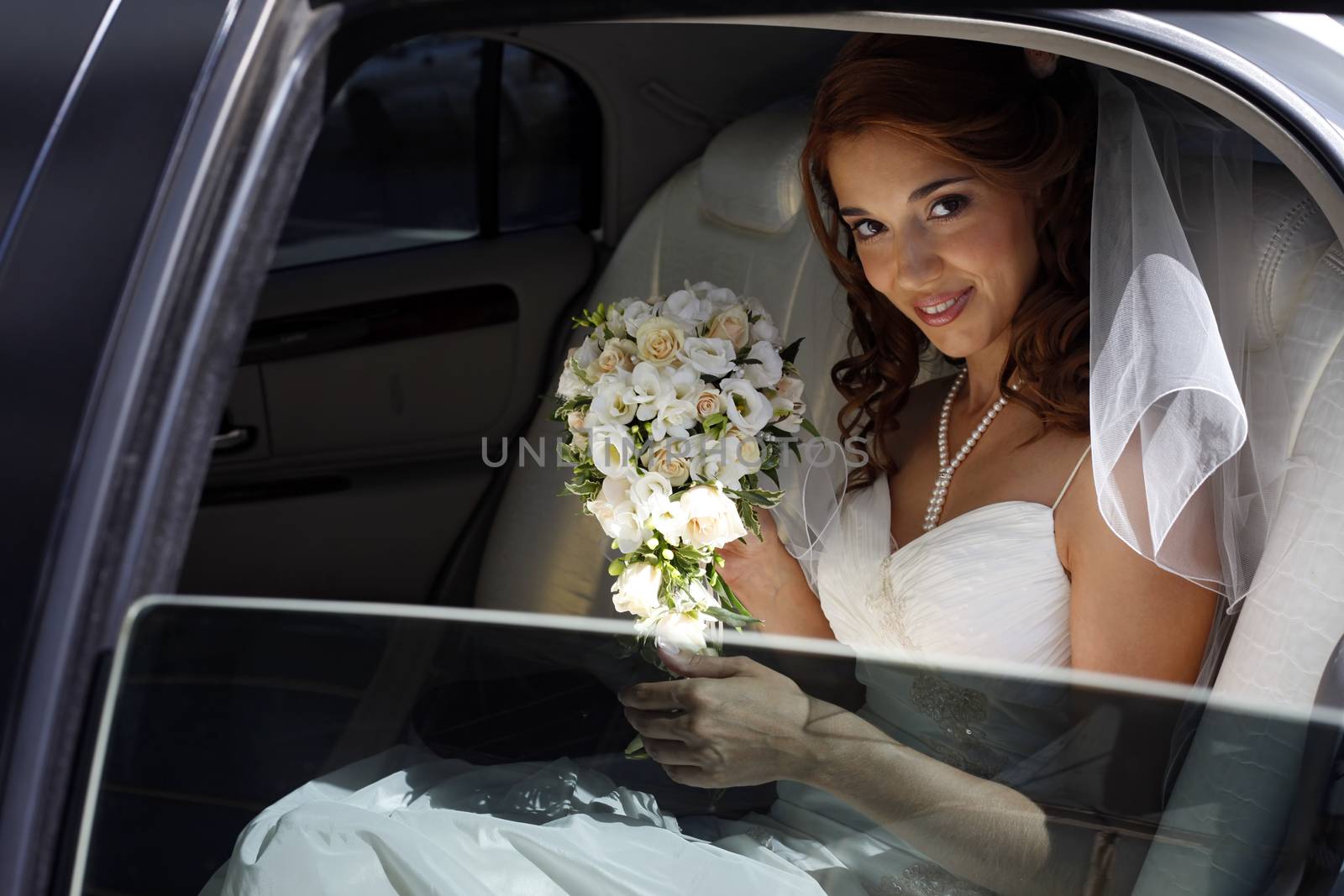 The beautiful bride in the automobile