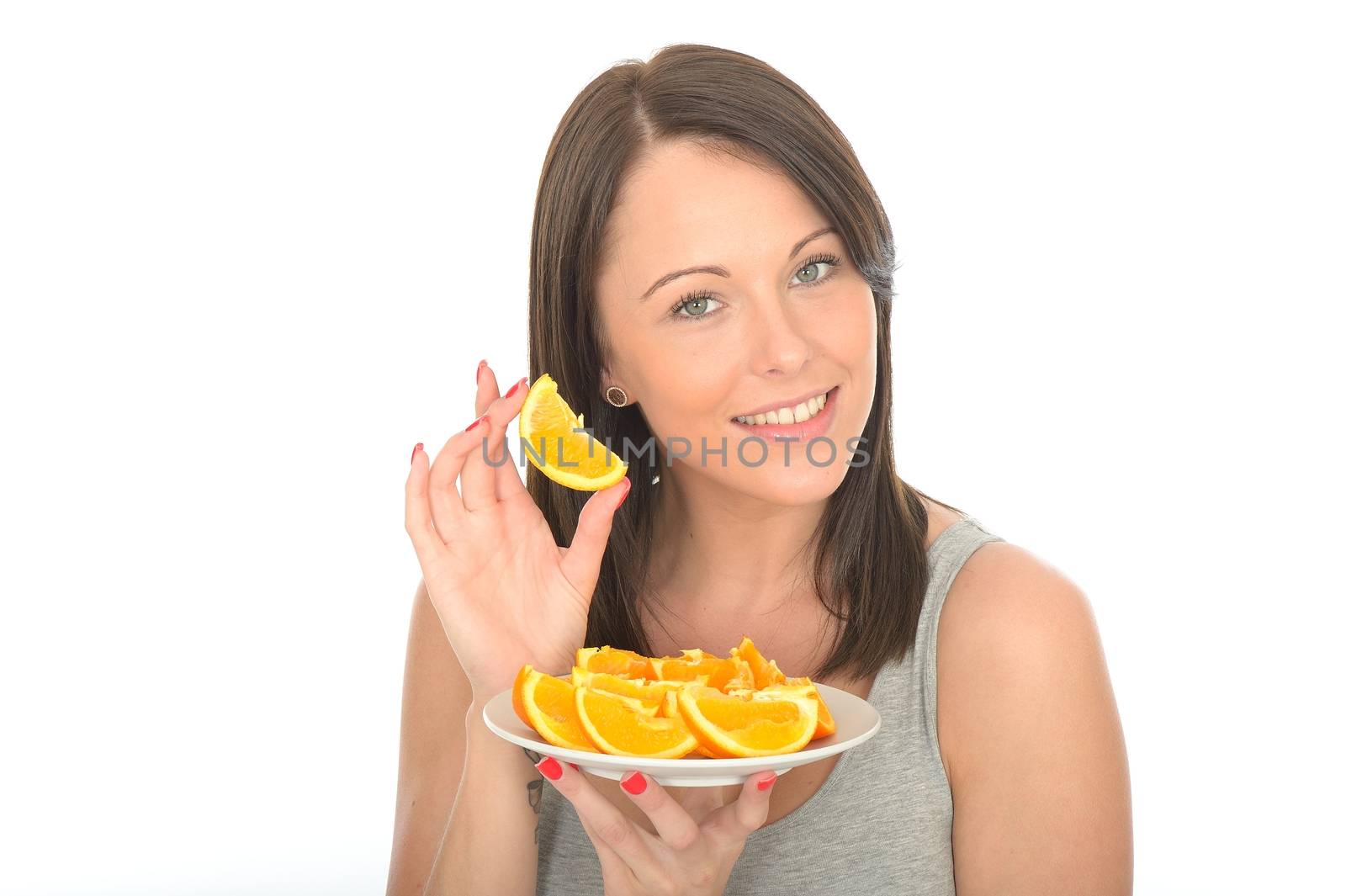 Attractive Young Woman Holding a Plate of Sliced Oranges by Whiteboxmedia