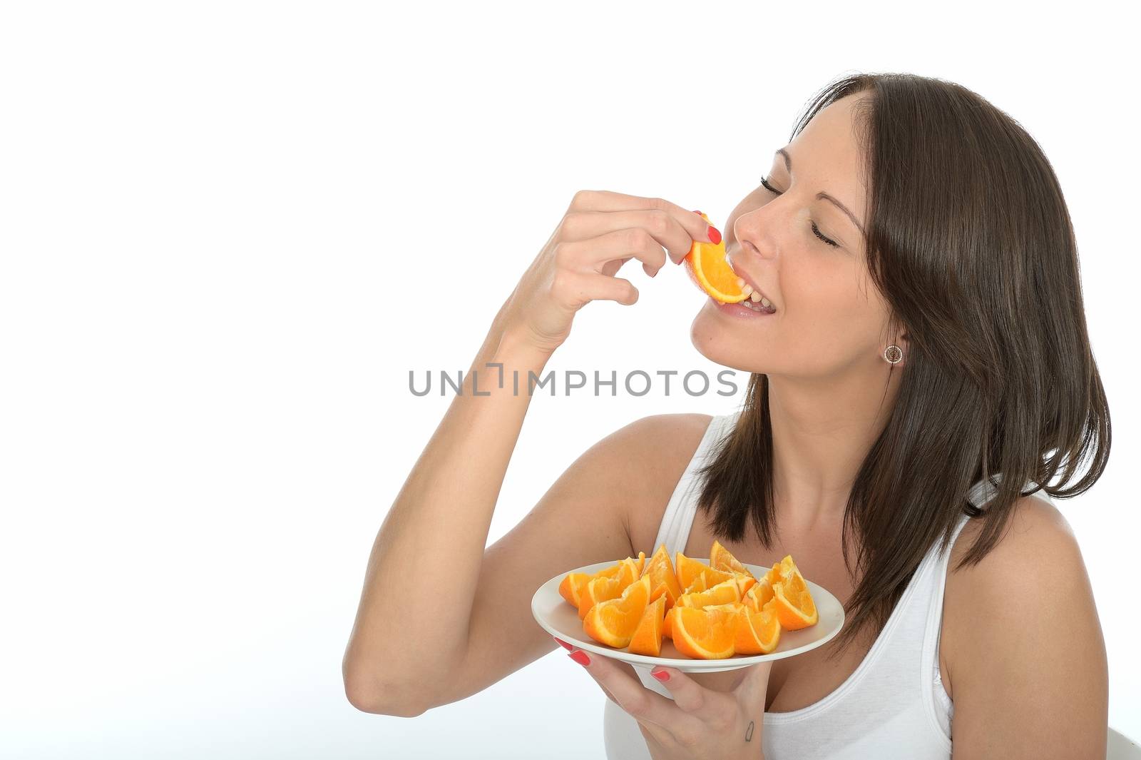 Healthy Young Woman Holding a Plate of Fresh Orange Segments by Whiteboxmedia