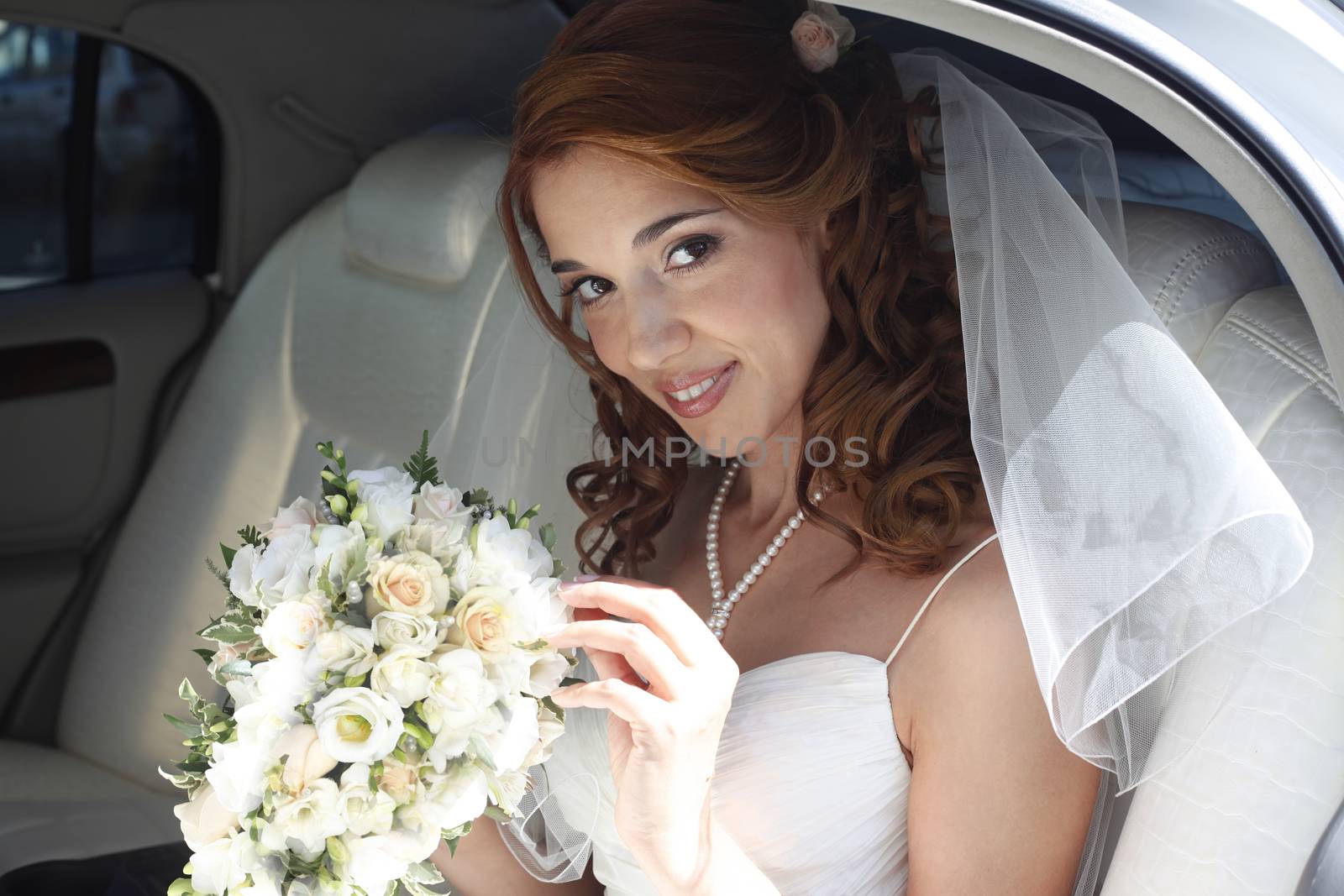 The beautiful bride in the automobile