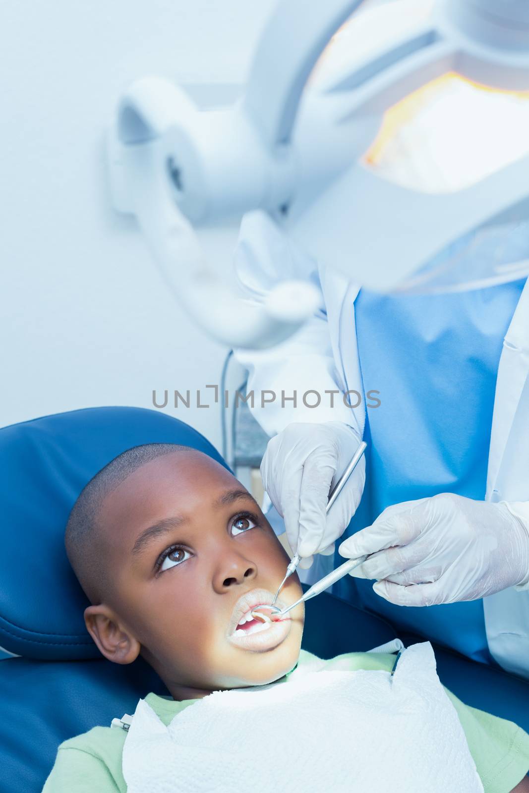 Close up of boy having his teeth examined by a dentist