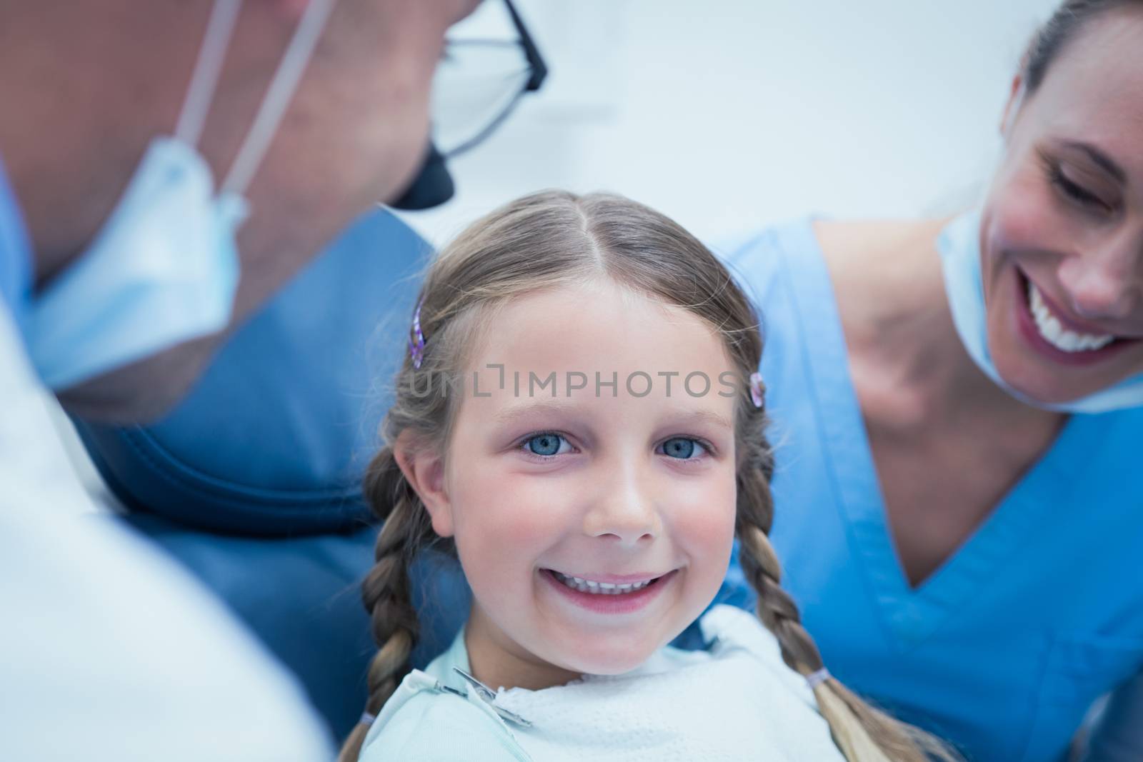 Close up portrait of girl having her teeth examined by dentist