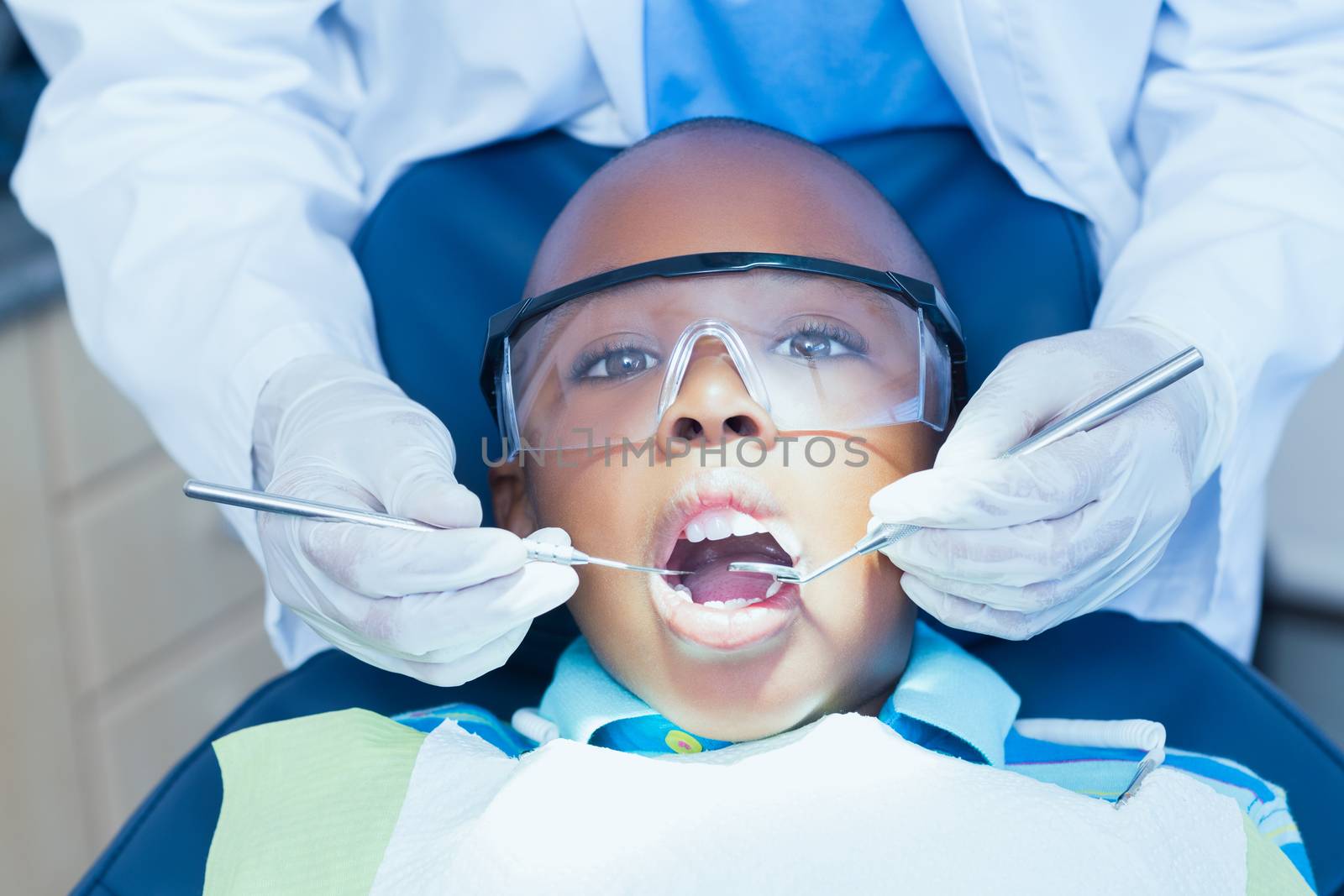 Close up of boy having his teeth examined by a dentist