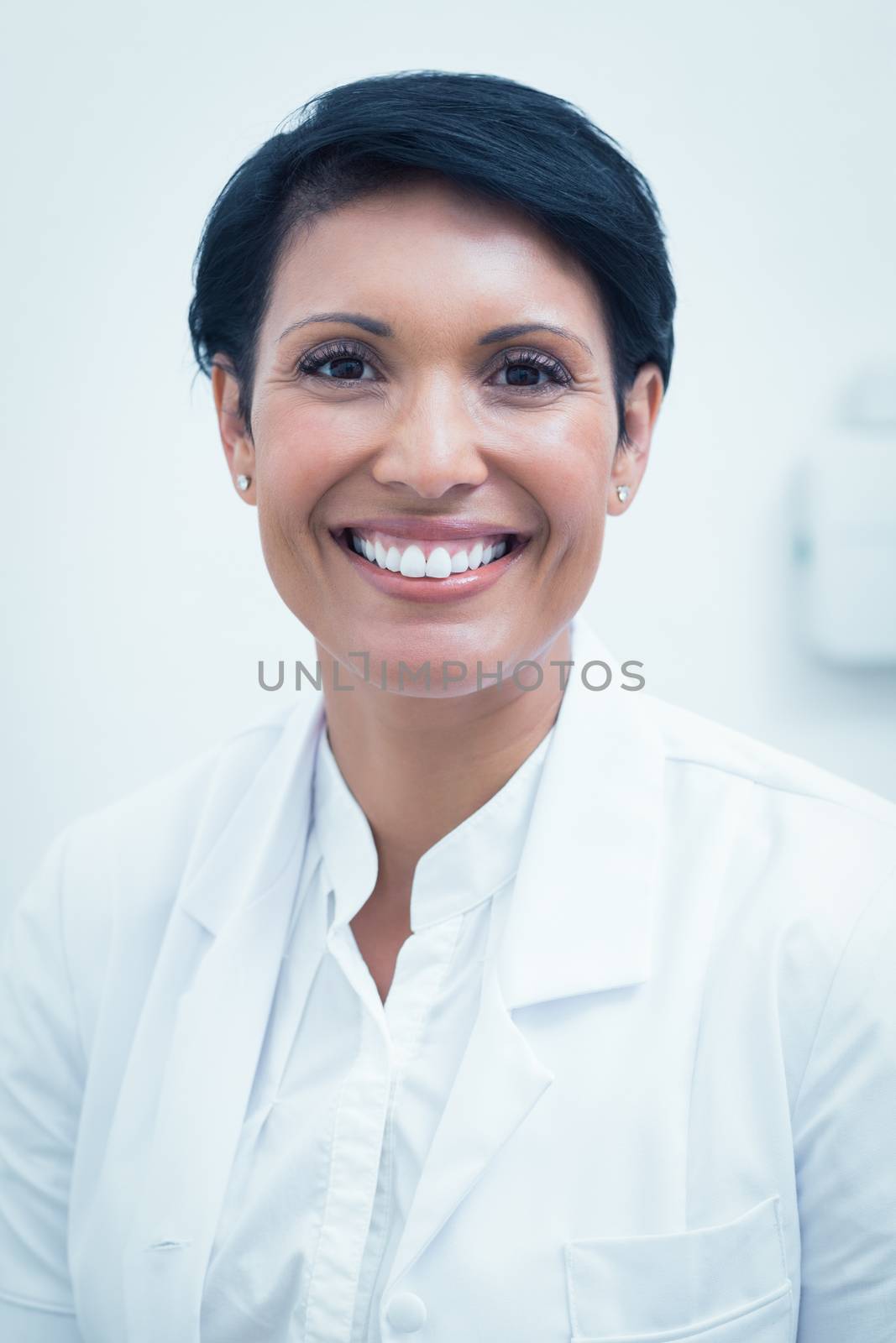 Confident female dentist smiling by Wavebreakmedia