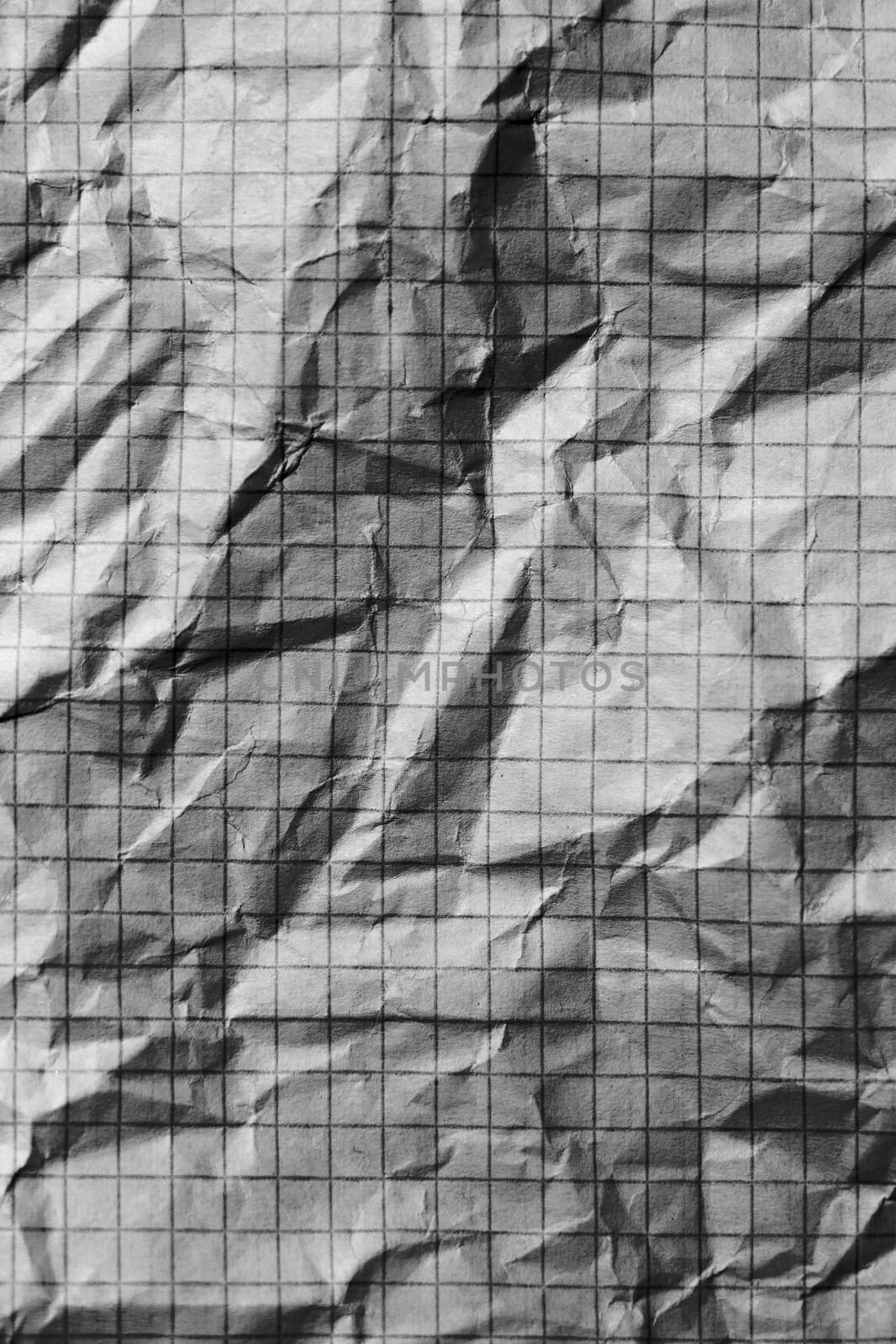 Part of the surface crumpled checkered paper. macro photo