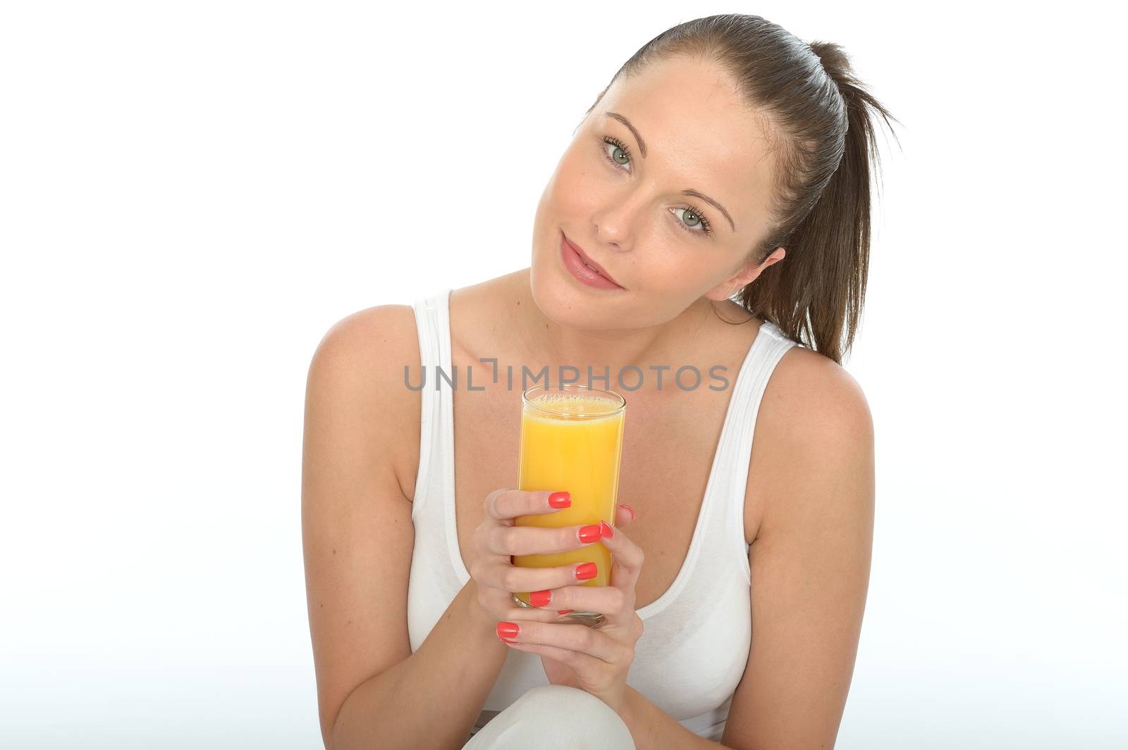 Healthy Happy Fit Young Woman Holding a Glass Of Fresh Orange Ju by Whiteboxmedia