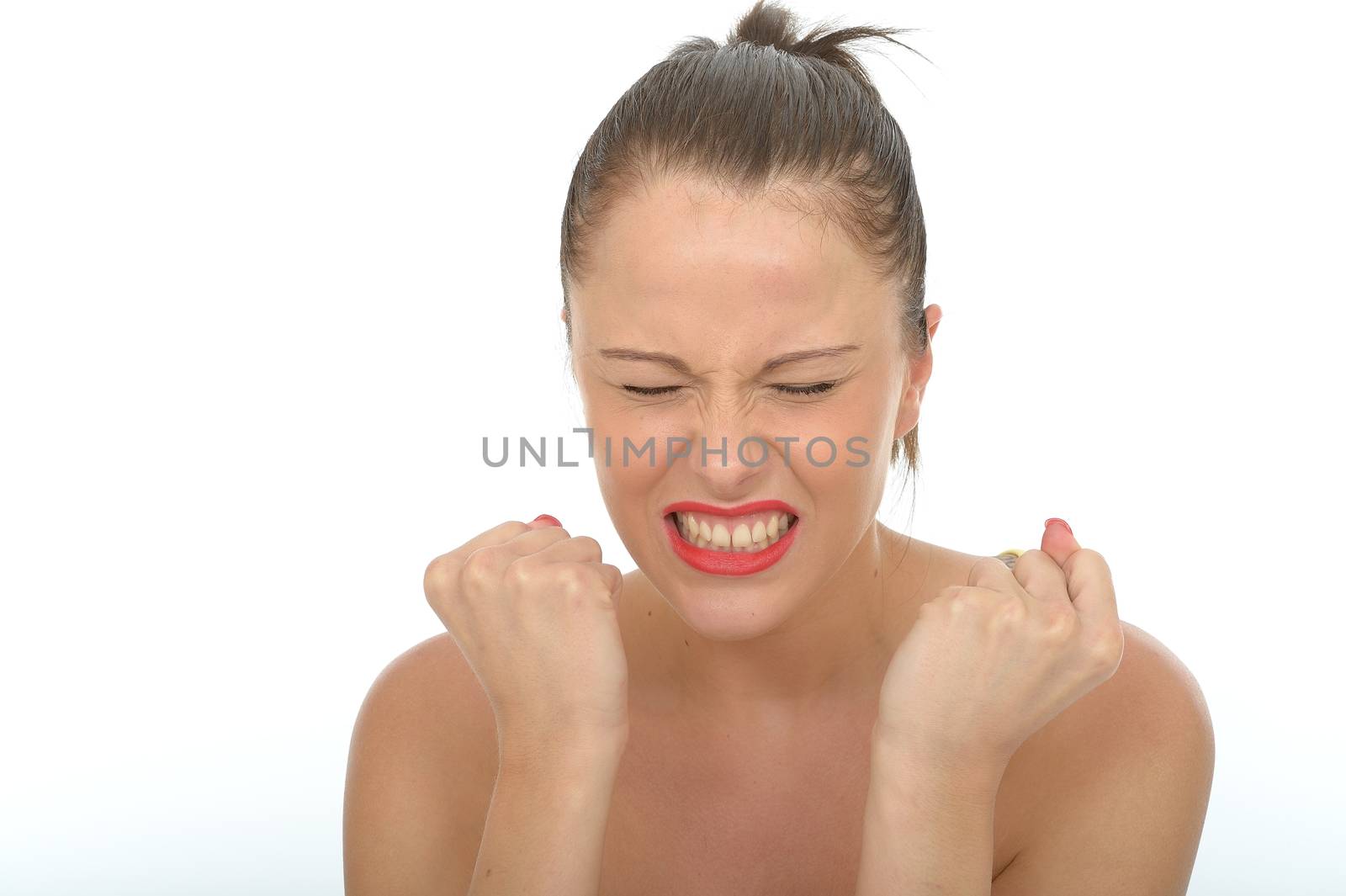 Portrait of an Excited Happy Young Woman With Clenched Fists Celebrating