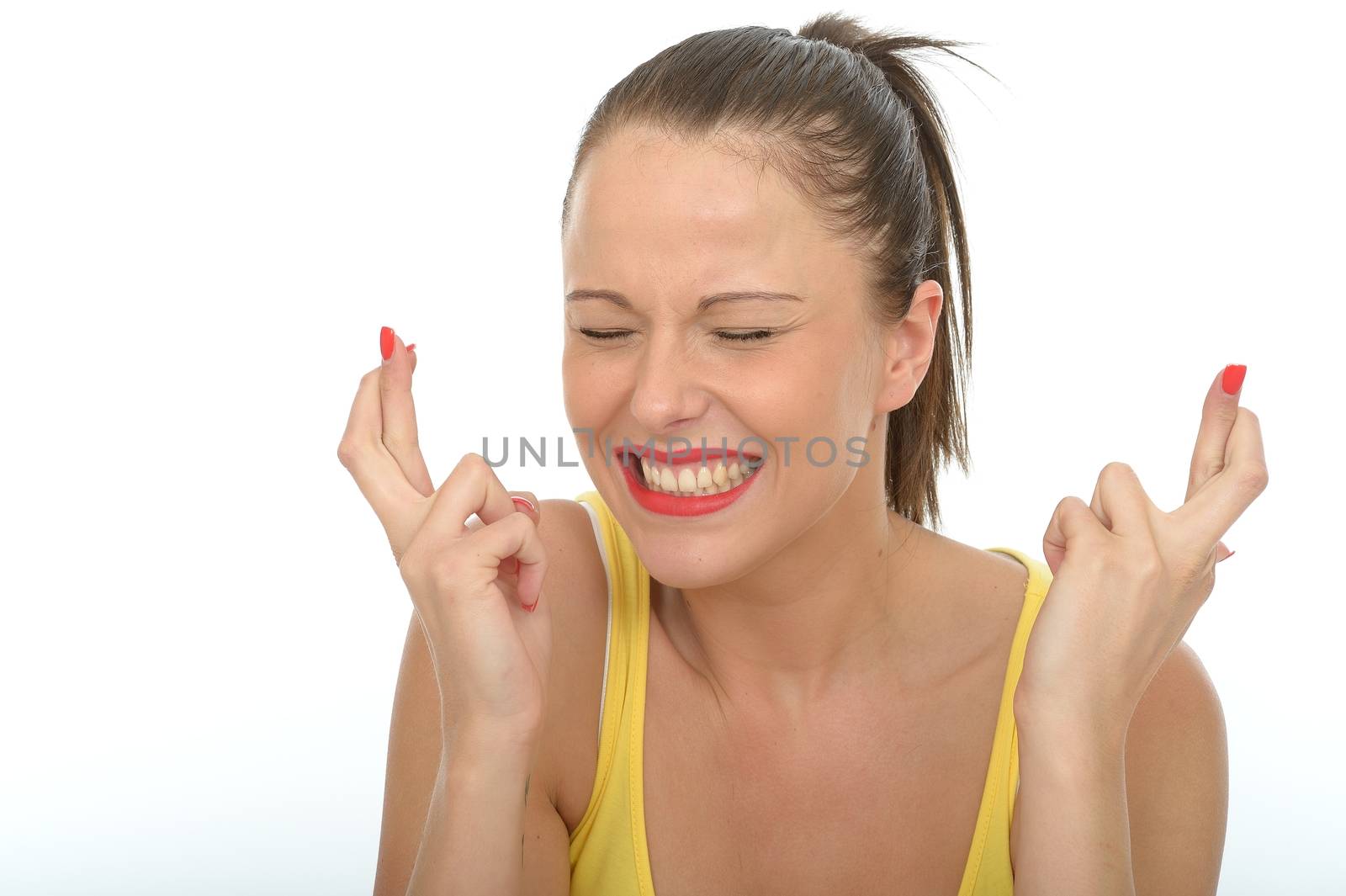 Portrait of a Happy Excited Young Woman With Her Fingers Crossed