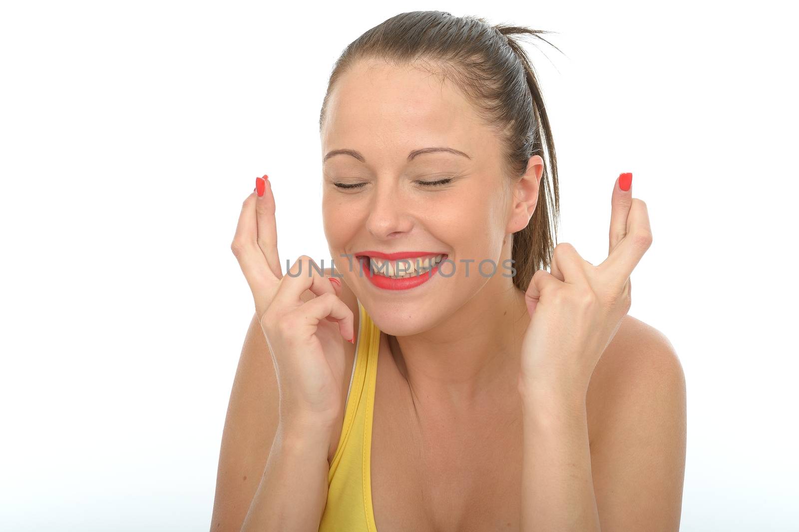 Portrait of a Happy Excited Young Woman With Her Fingers Crossed