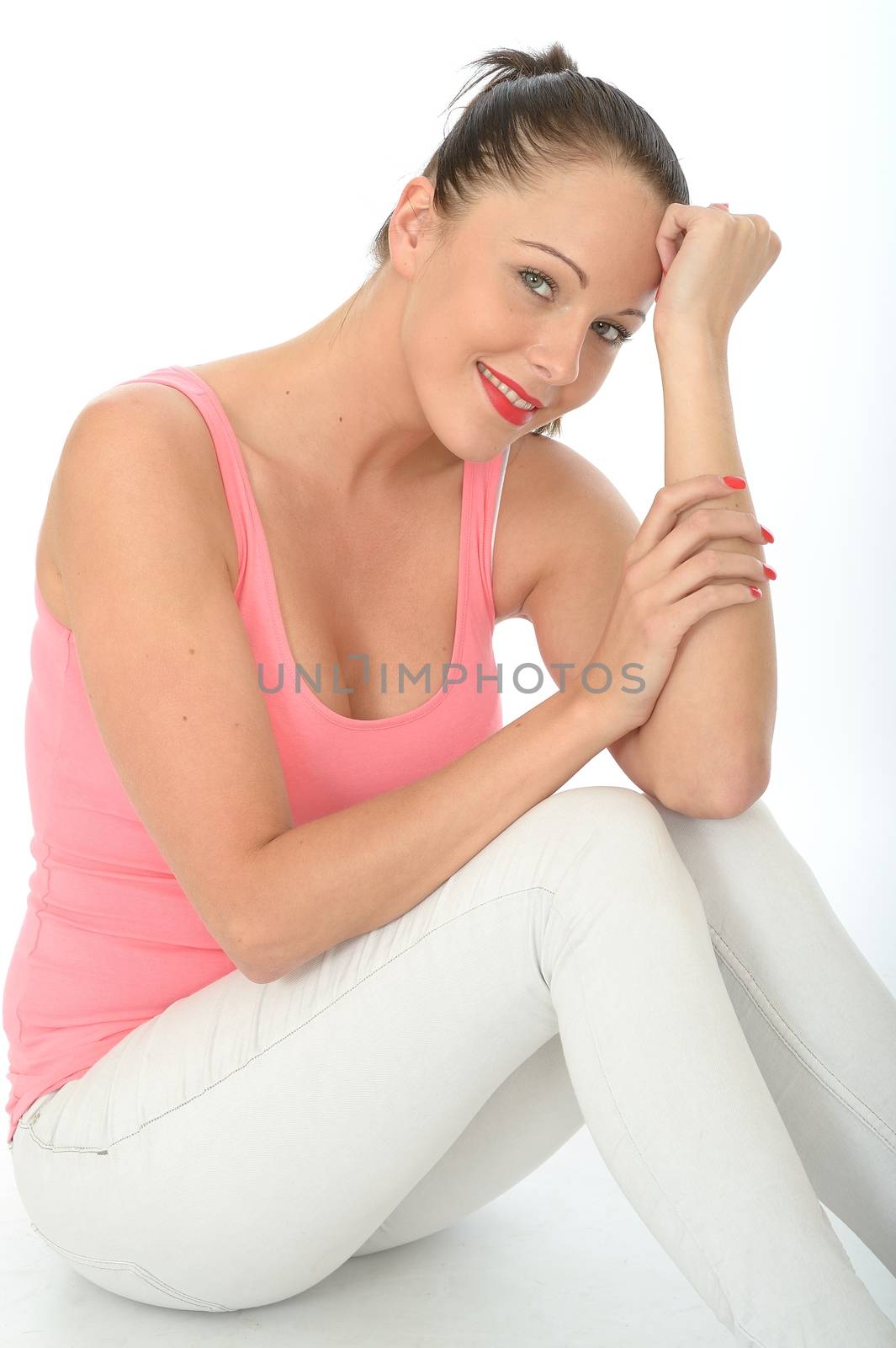 Portrait of a Relaxed Happy Attractive Young Woman Sitting on the Floor Smiling and Pleased