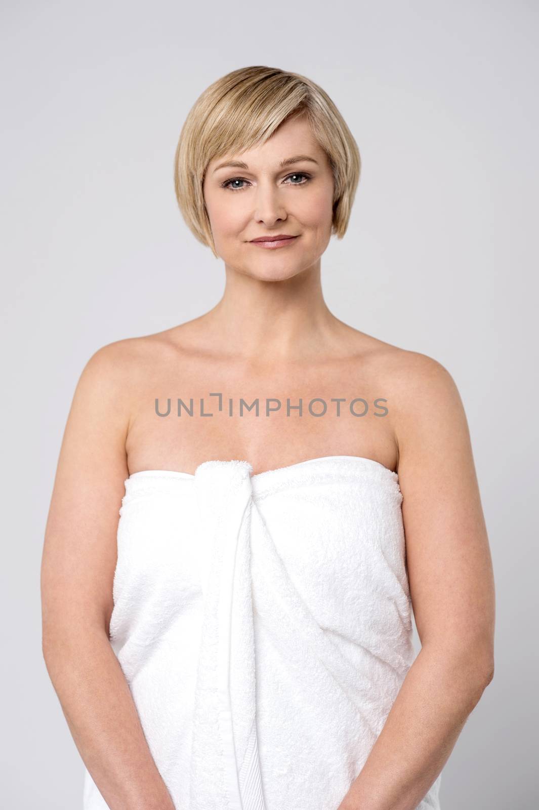 Middle aged woman wrapped in towel