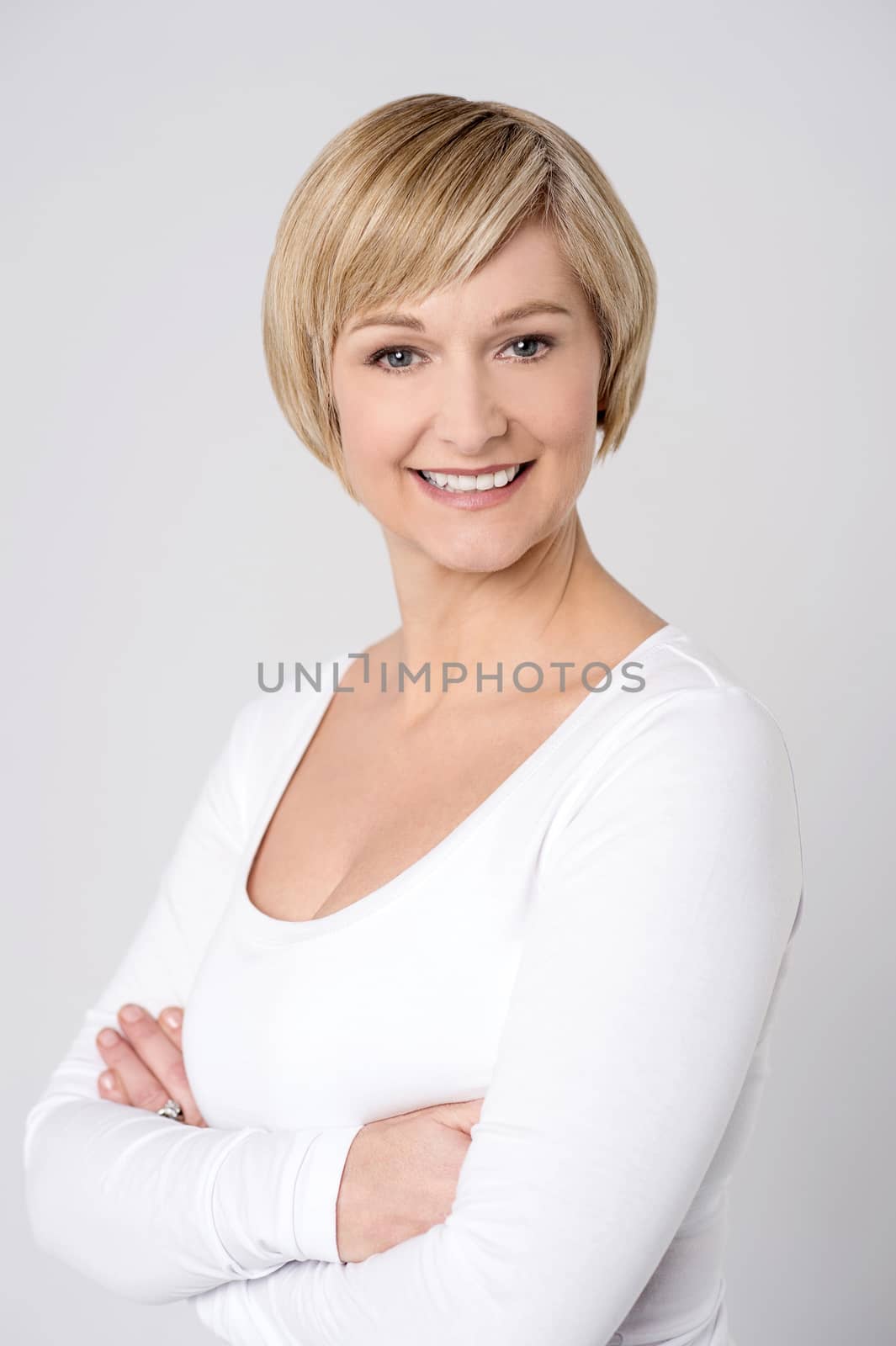 Confident woman posing over grey by stockyimages