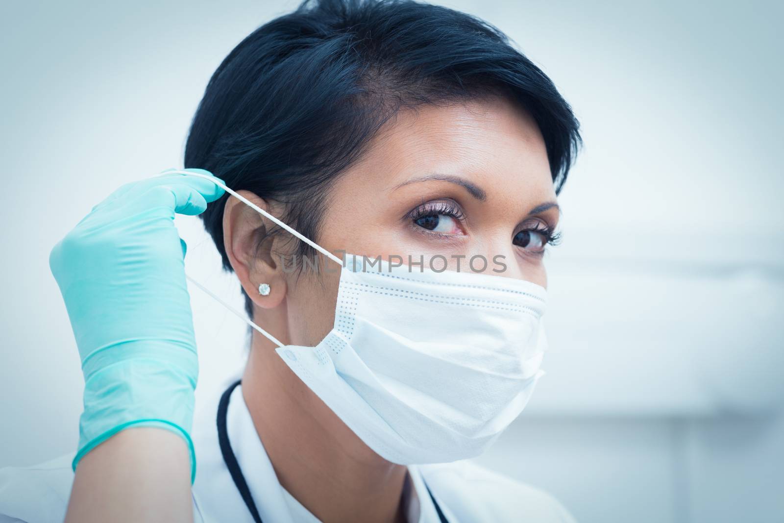 Female dentist wearing surgical mask by Wavebreakmedia