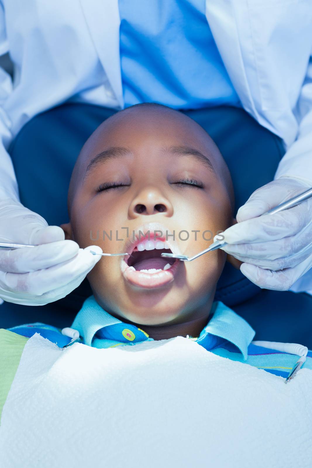 Close up of boy having his teeth examined by Wavebreakmedia