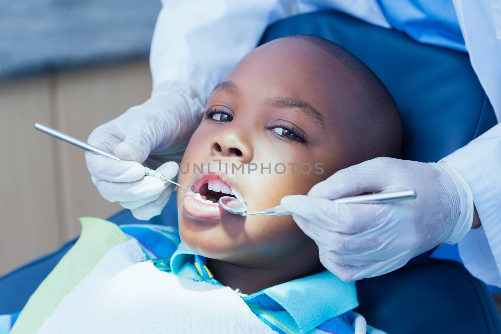 Close up of boy having his teeth examined by a dentist