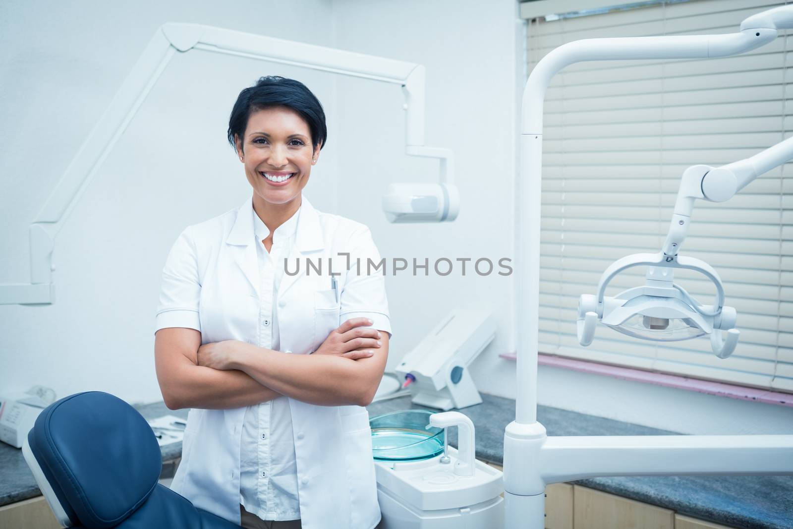 Female dentist with arms crossed by Wavebreakmedia