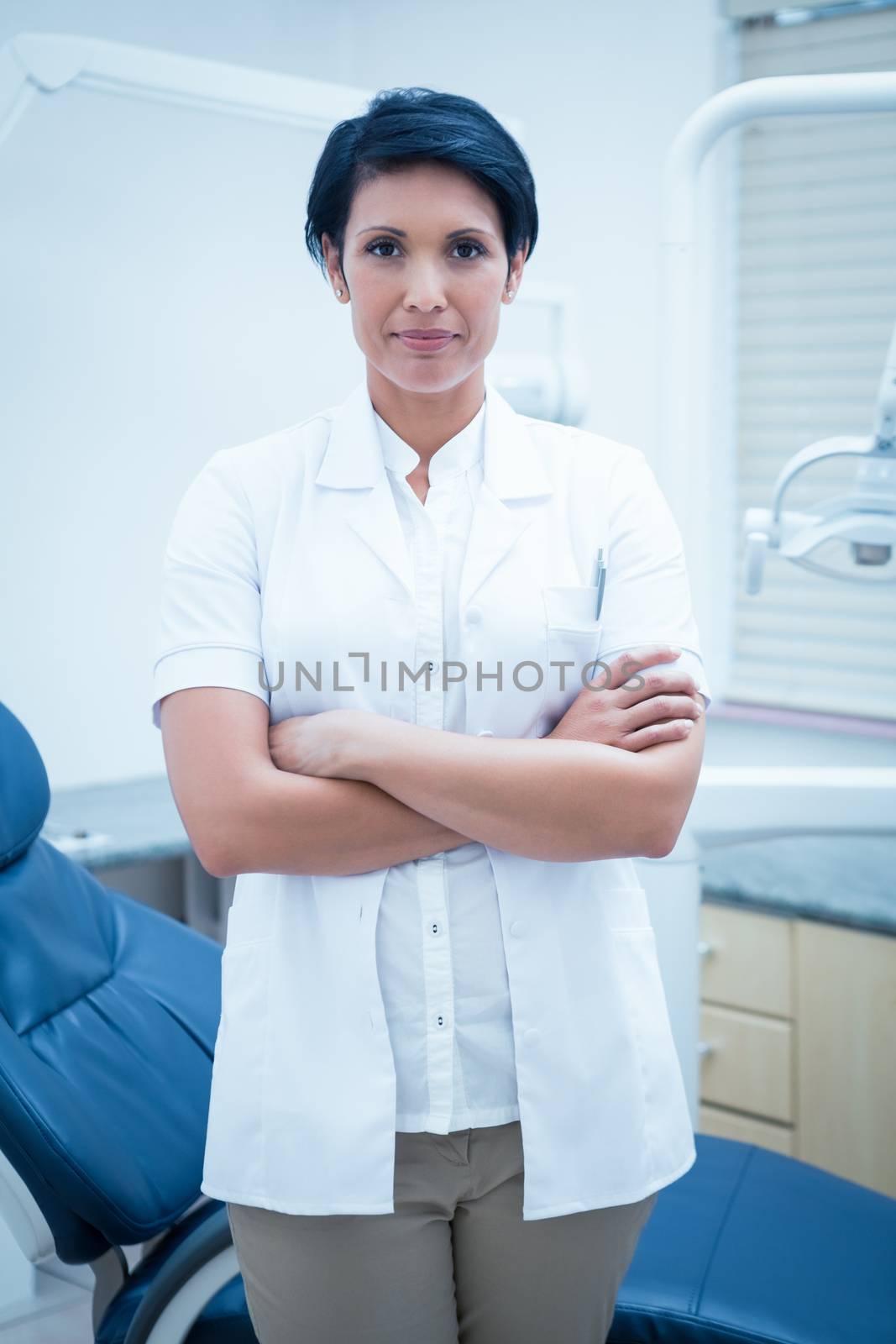 Portrait of confident female dentist with arms crossed